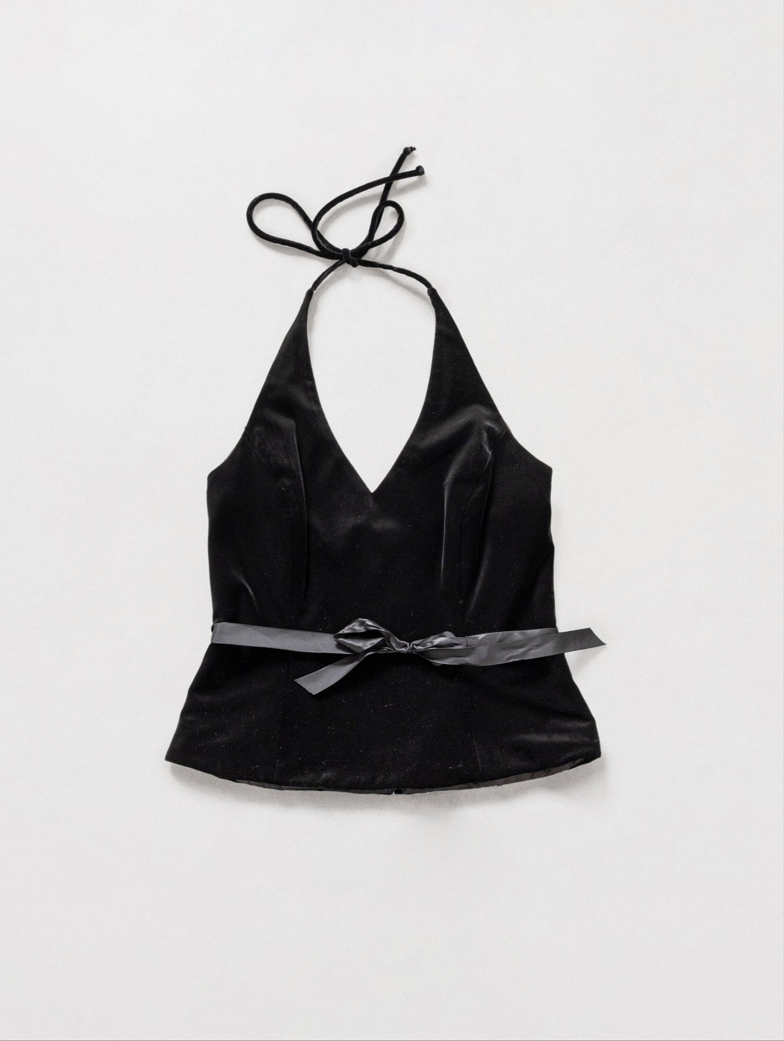 Black satin halter top with a bow on a white background