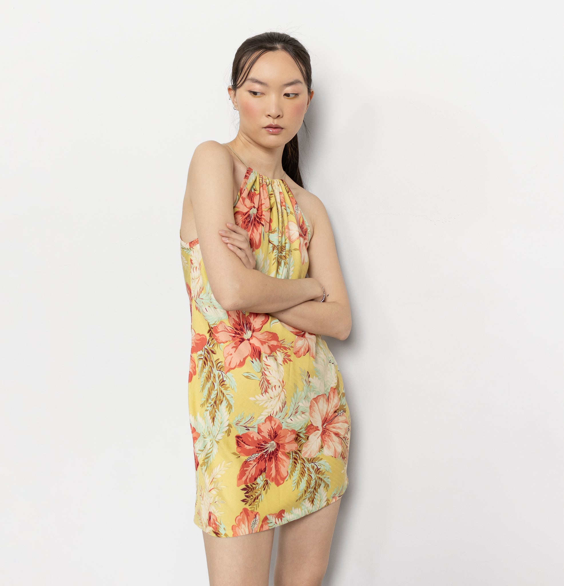 Woman wearing a floral dress against a plain background