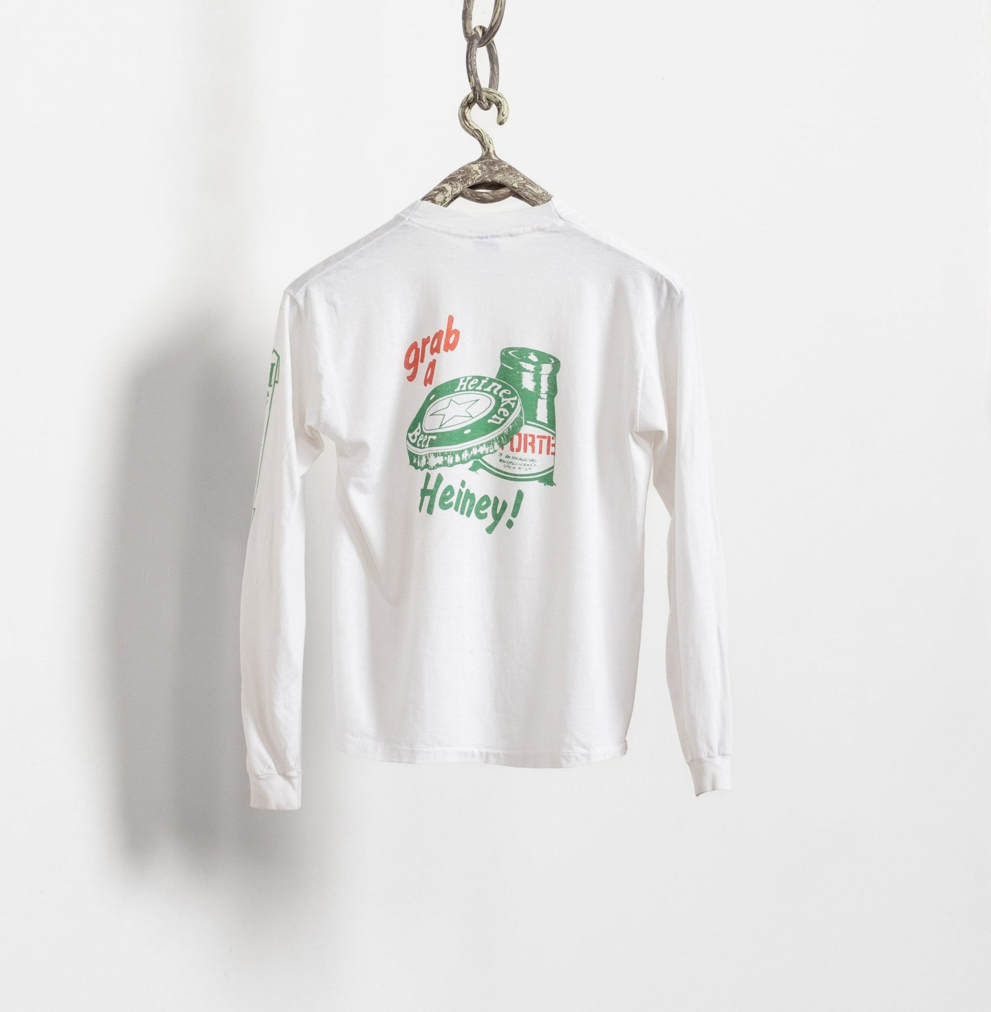White long-sleeve shirt with vintage graphic and text on a white background