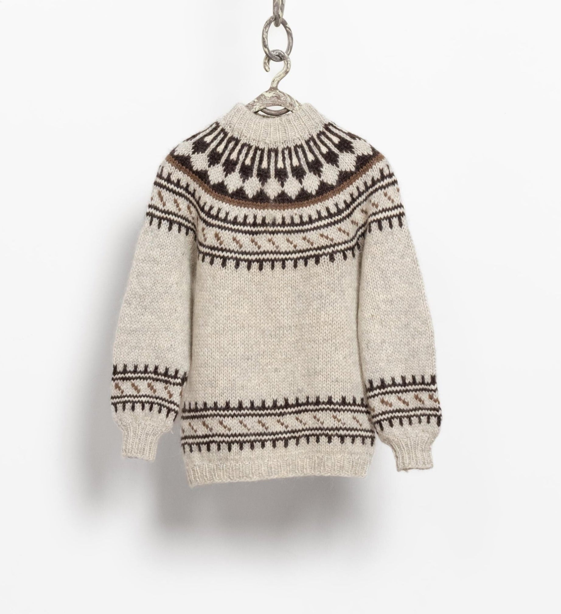A vintage Icelandic wool knit sweater with a fair isle pattern in beige and brown tones, displayed on a white background.
