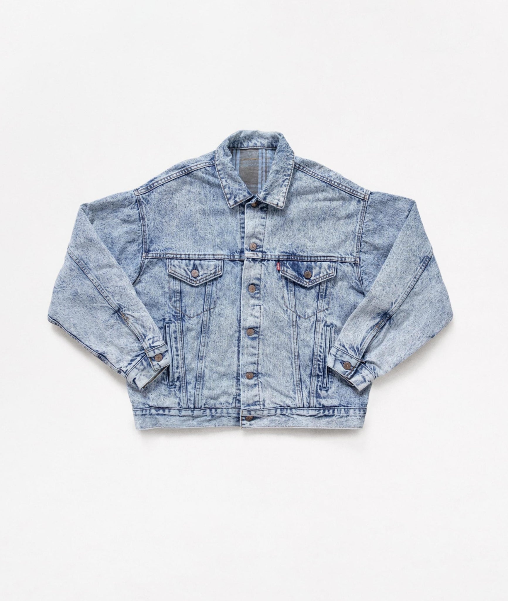 Aged blue denim jacket on a white background