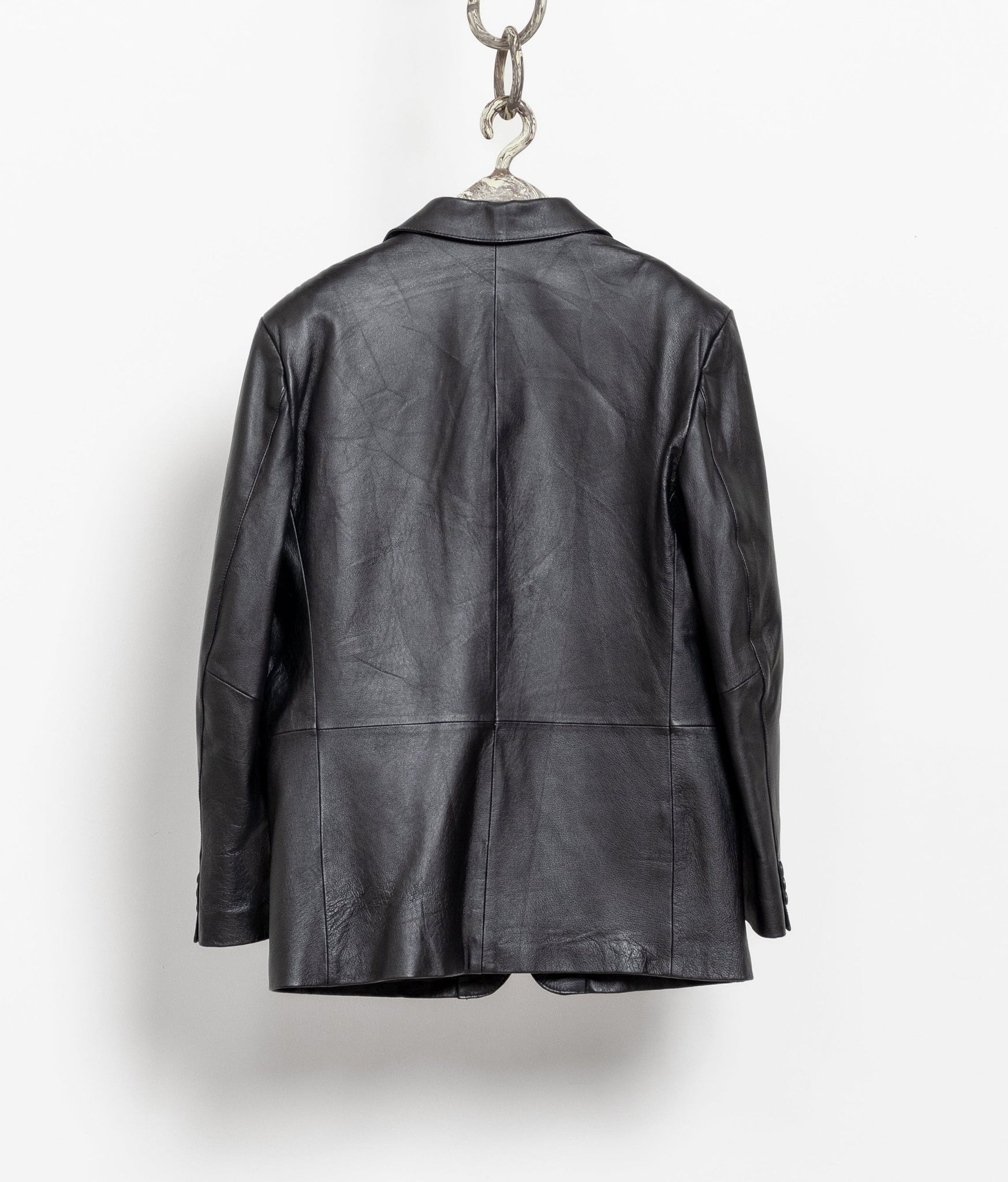 Black leather jacket hanging on a white background