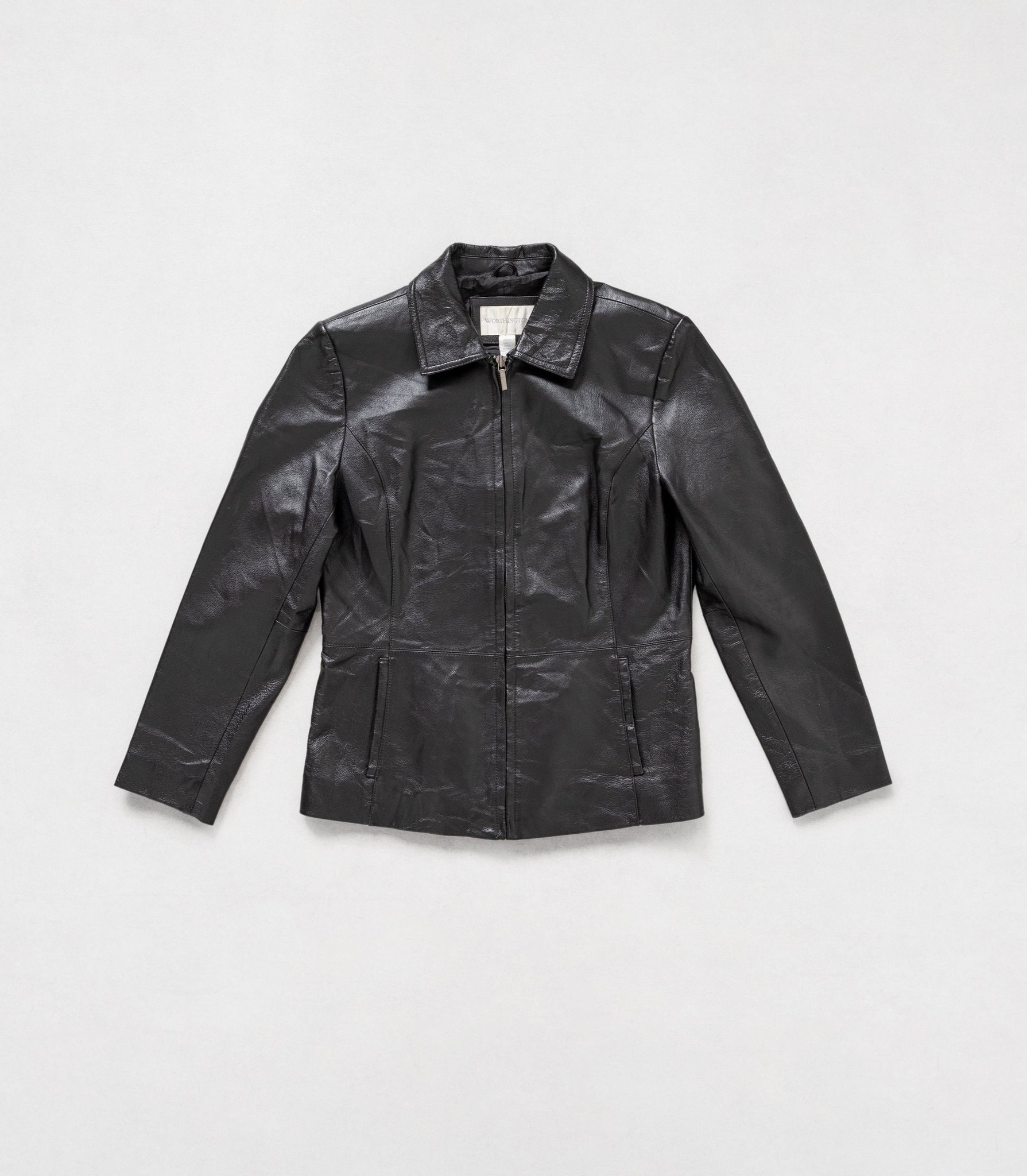 Black leather jacket on a light gray background
