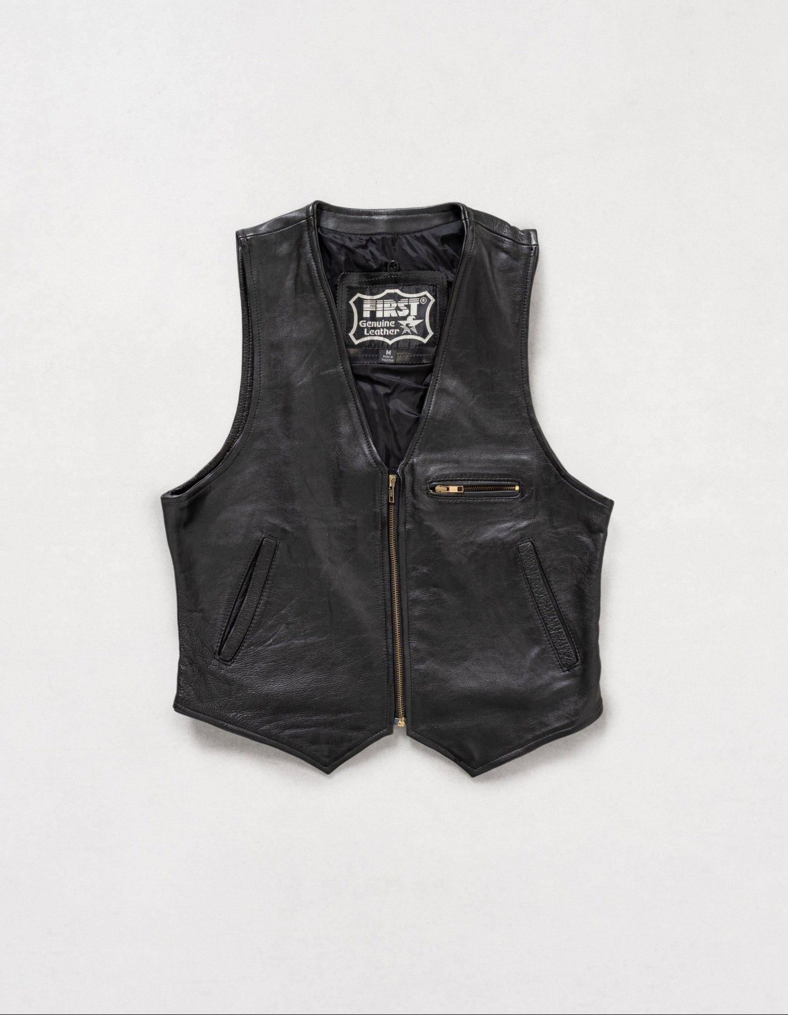 Black leather vest with a brand logo on a white background