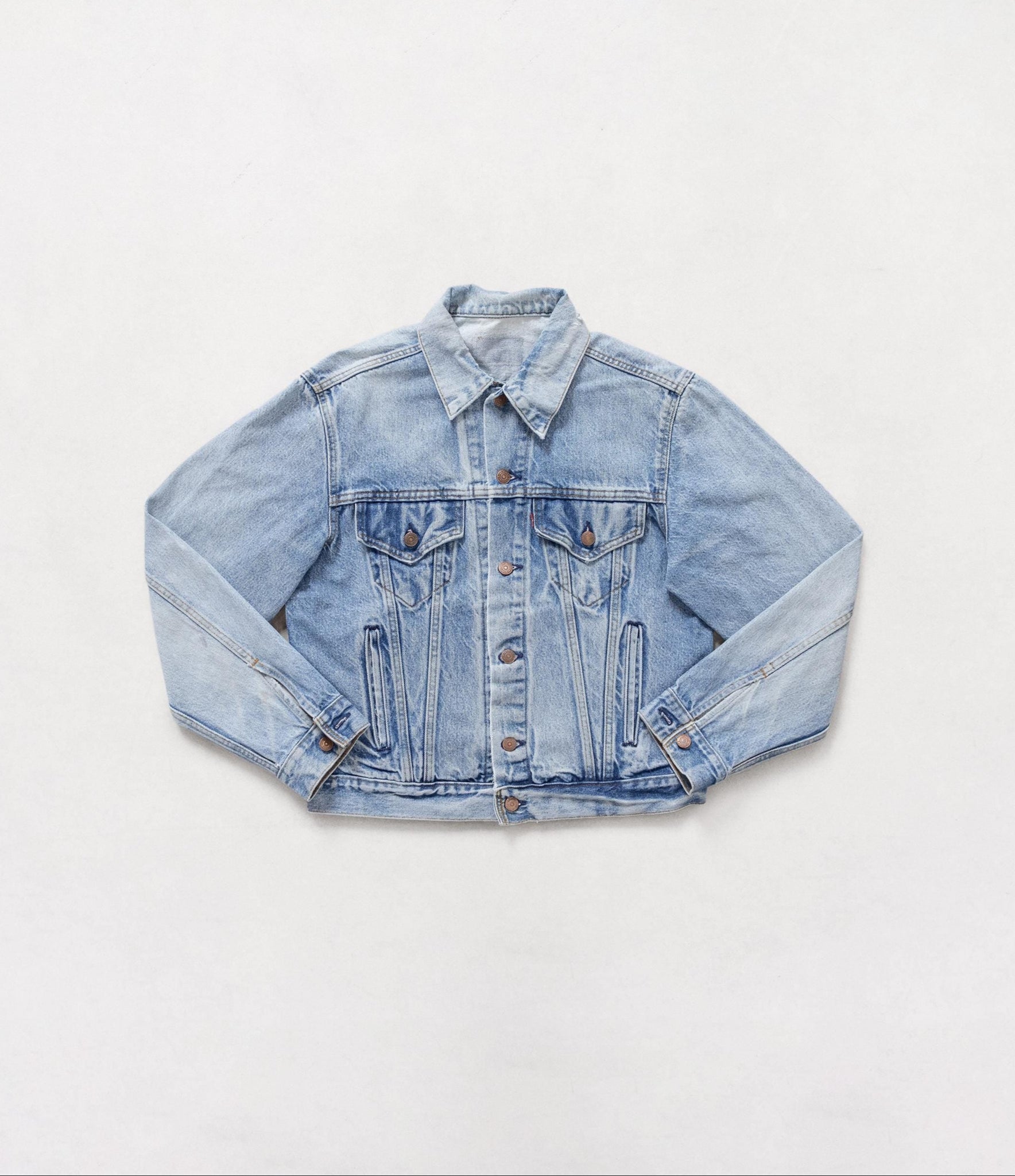 Light blue denim jacket on a white background