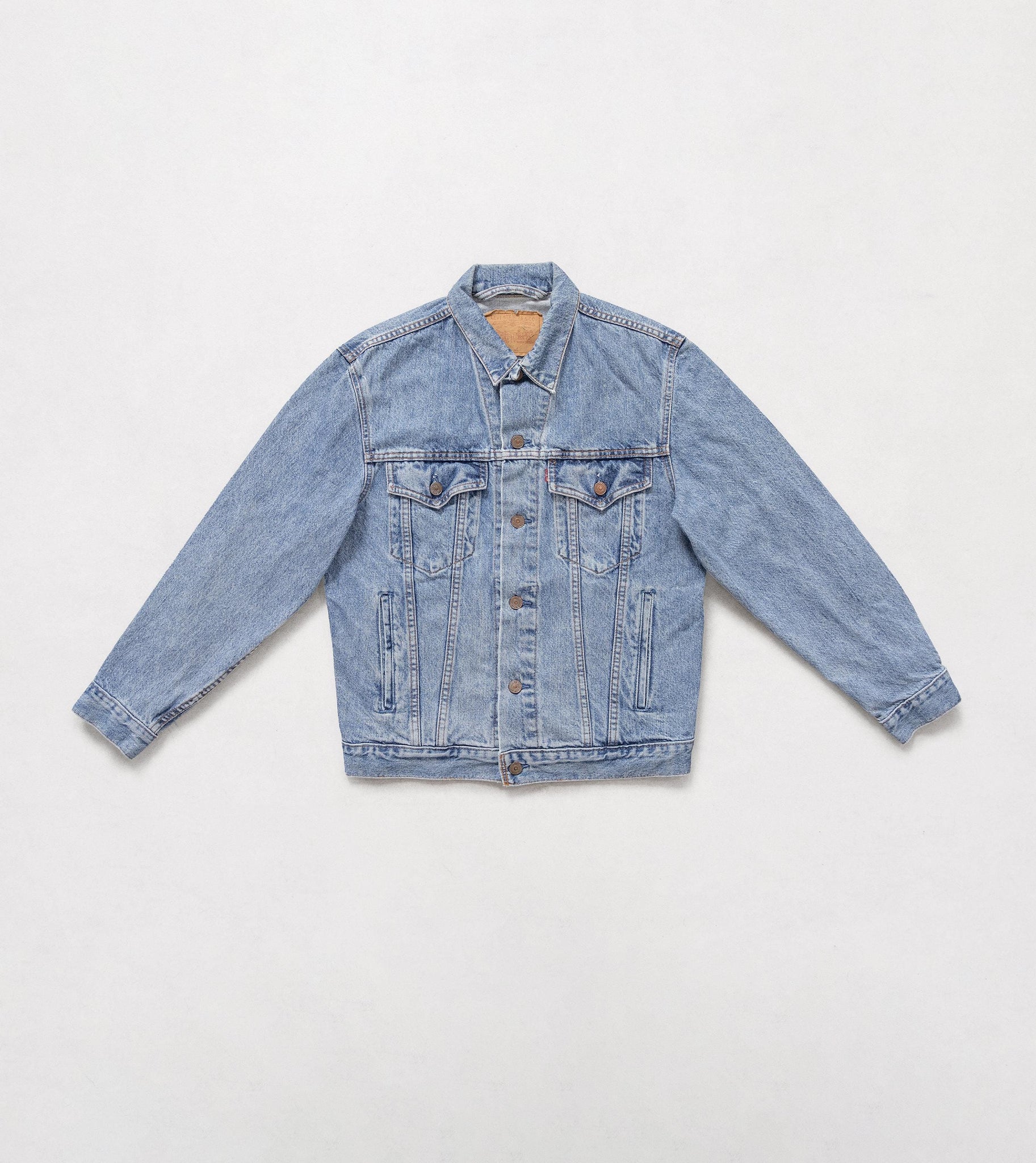 Light blue denim jacket on a white background