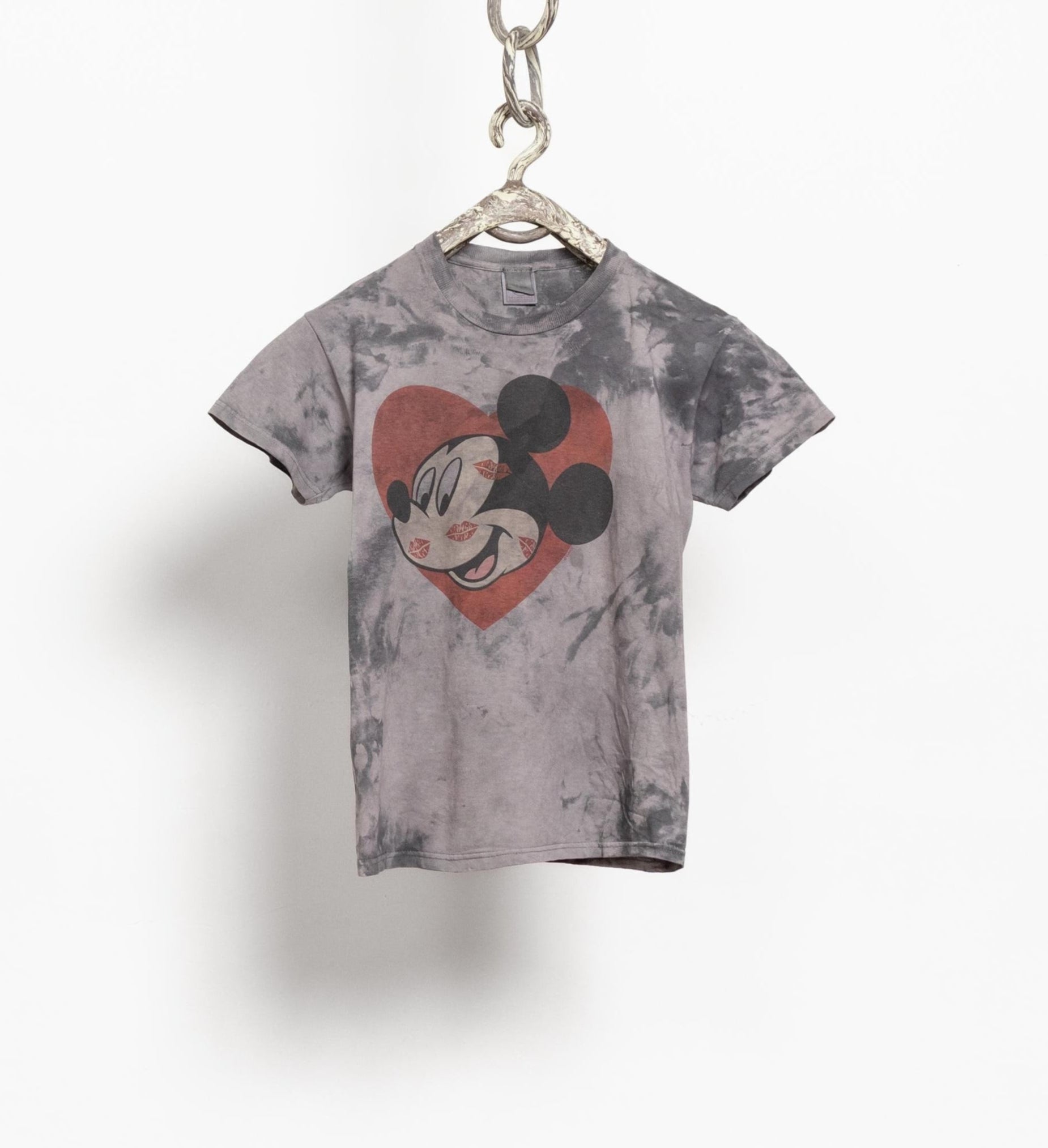 Gray tie-dye t-shirt with a heart-shaped Mickey Mouse design on a hanger against a white background