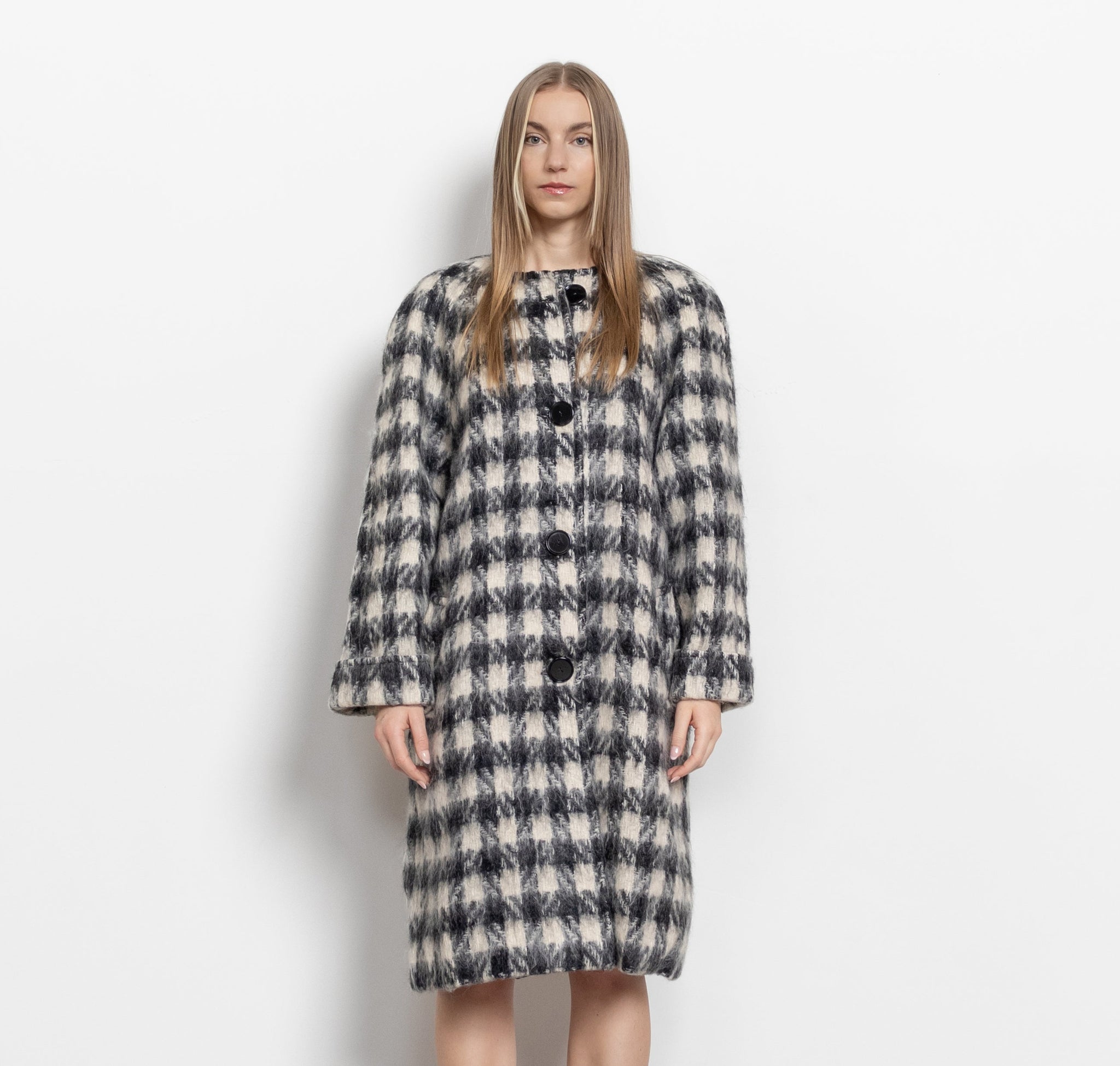 Woman wearing a plaid coat on a white background