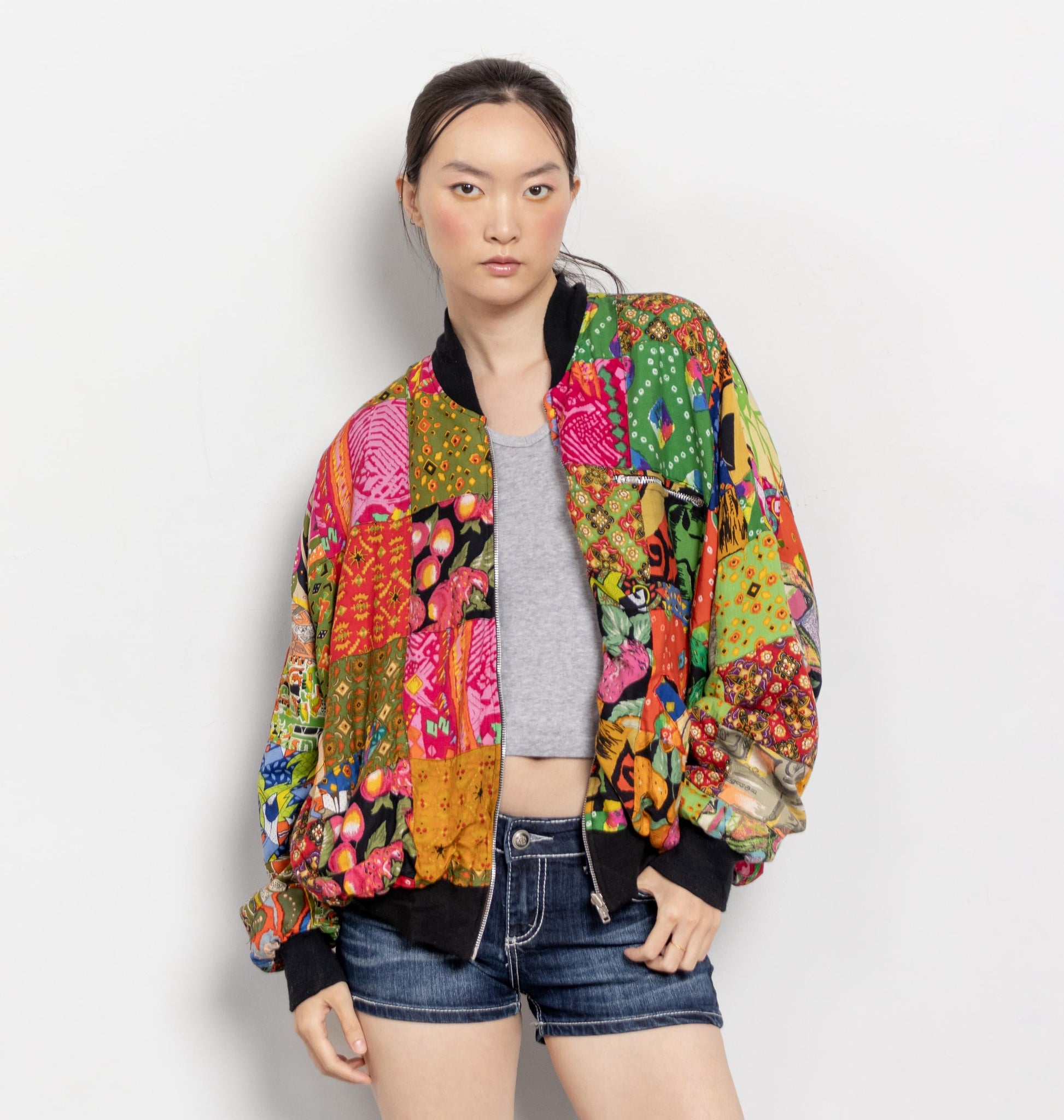 Person wearing a colorful patterned jacket on a white background