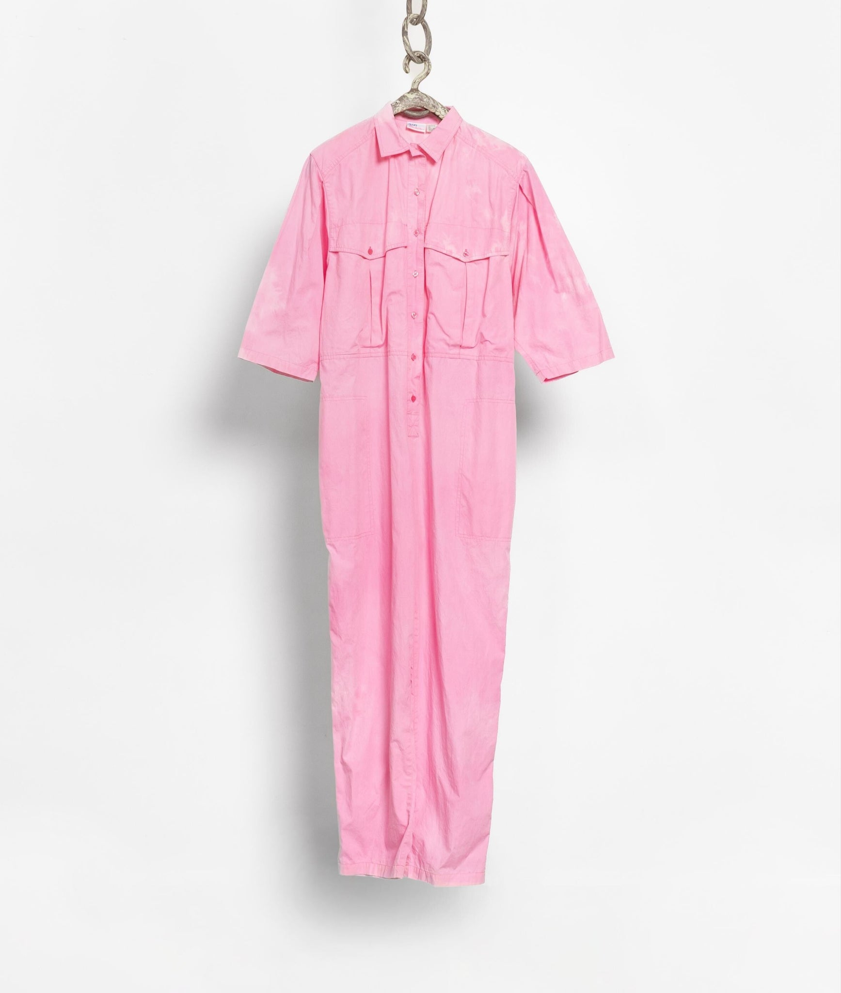 Pink coverall hanging on a white background