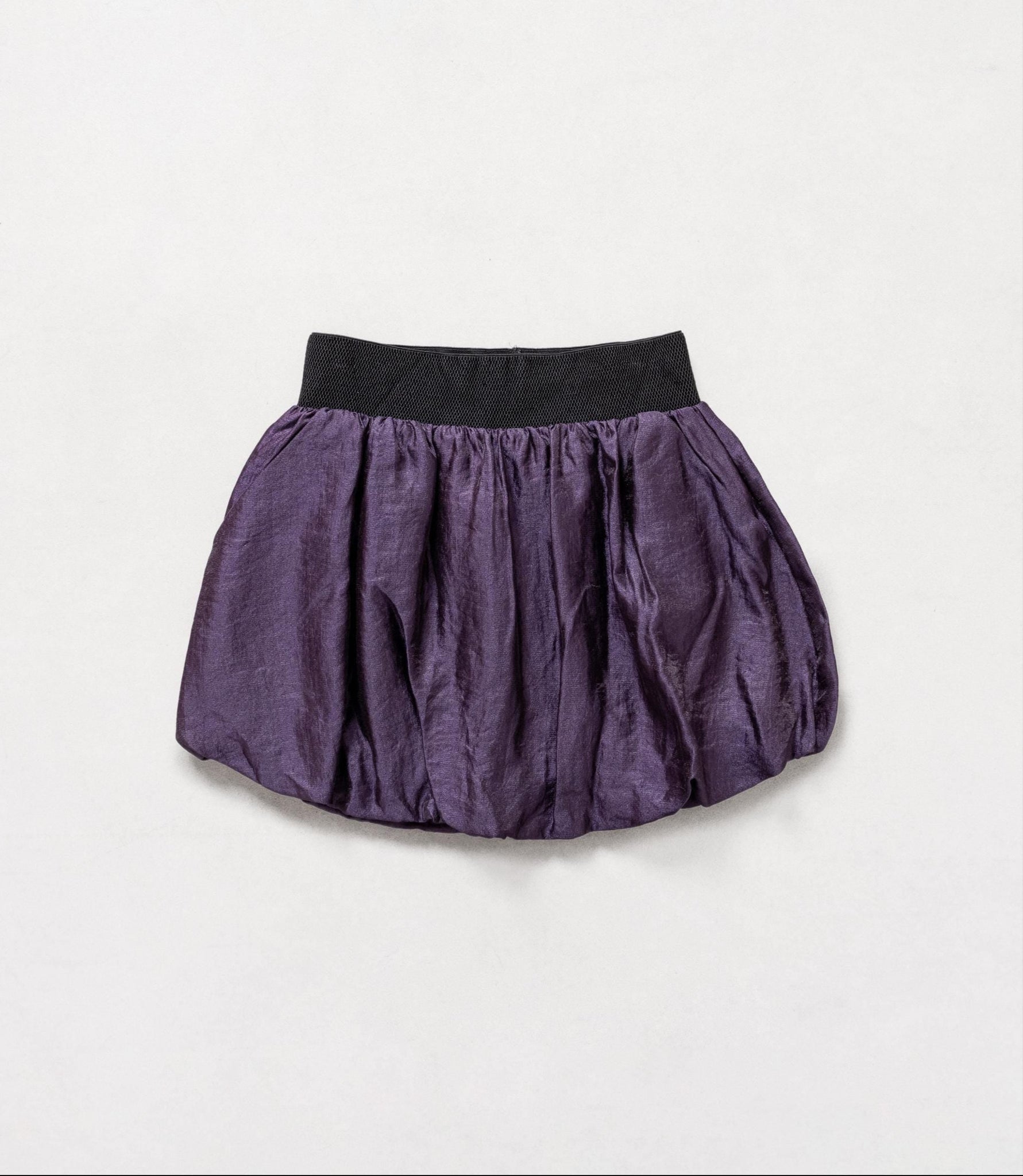 Purple skirt with black waistband on a light gray background