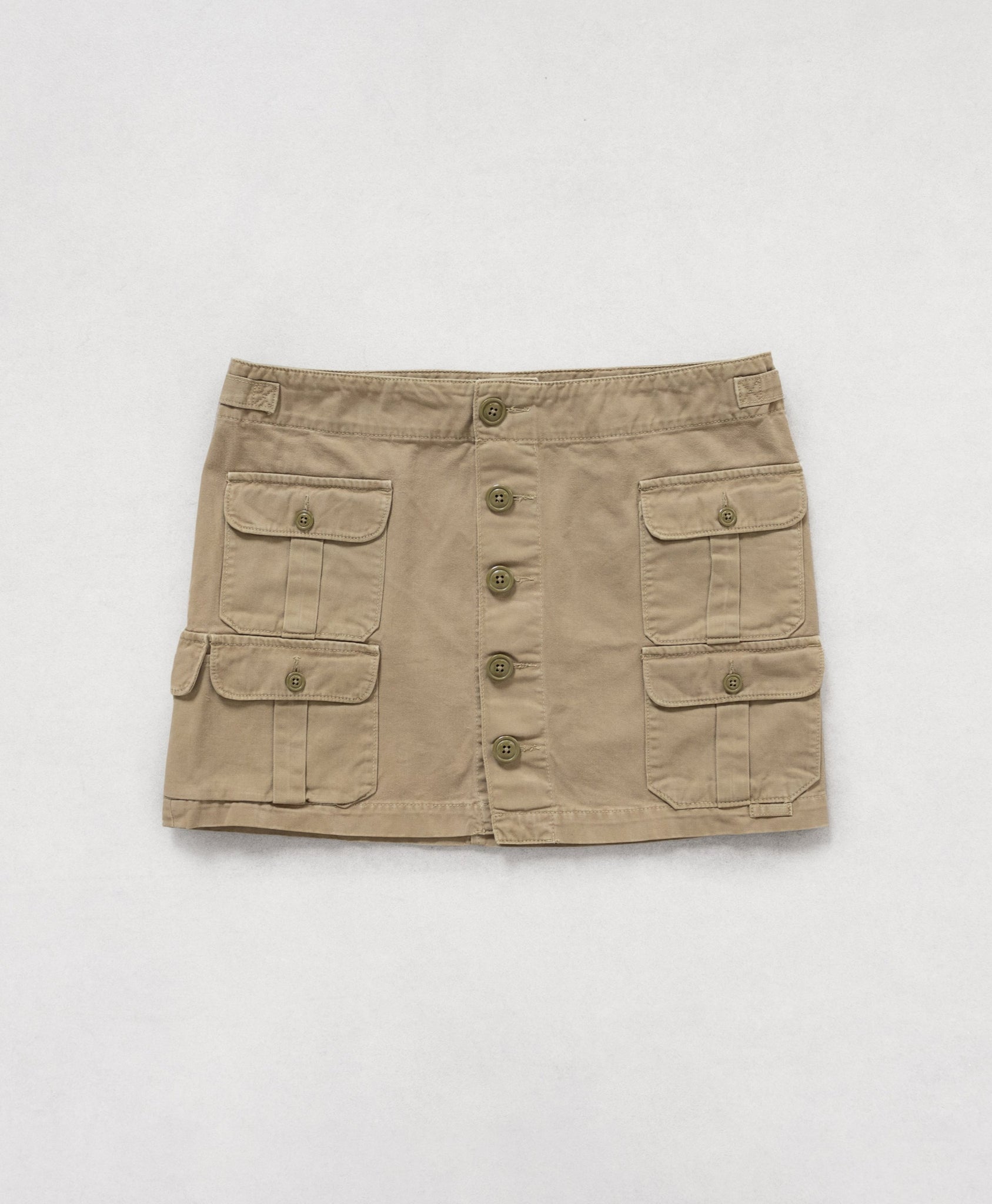 Beige skirt with button details on a white background
