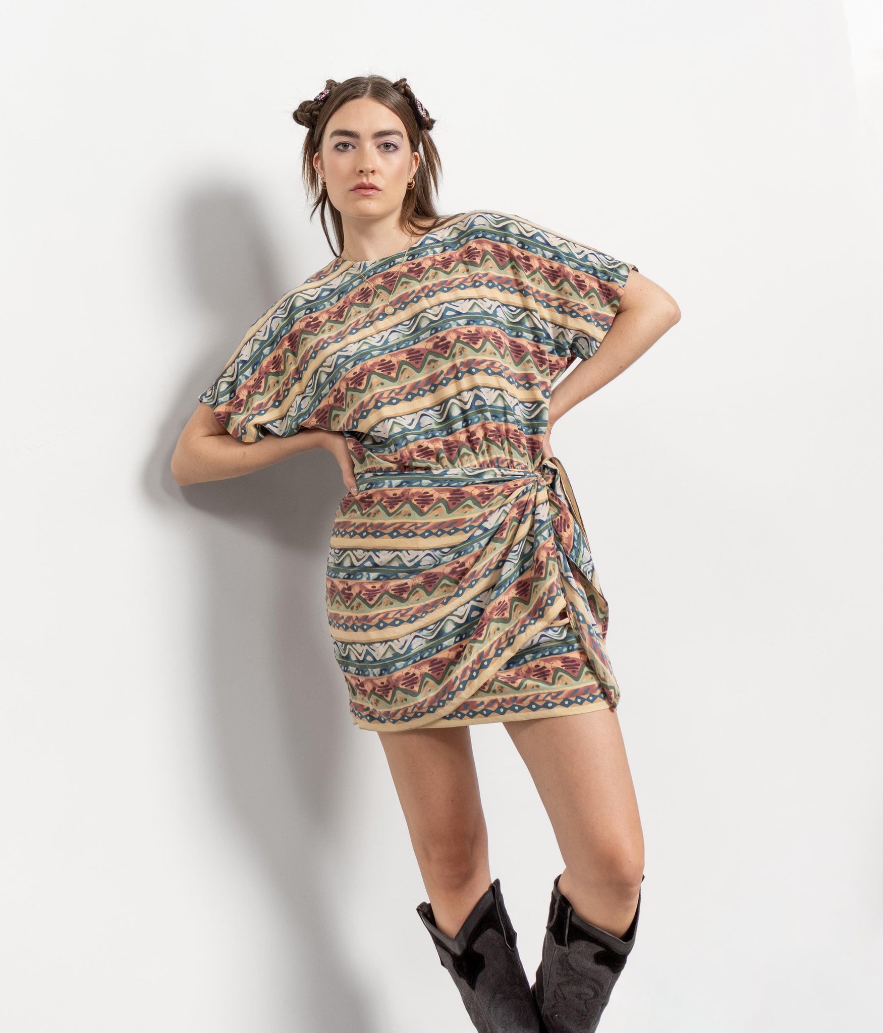 Woman wearing a patterned dress against a white background
