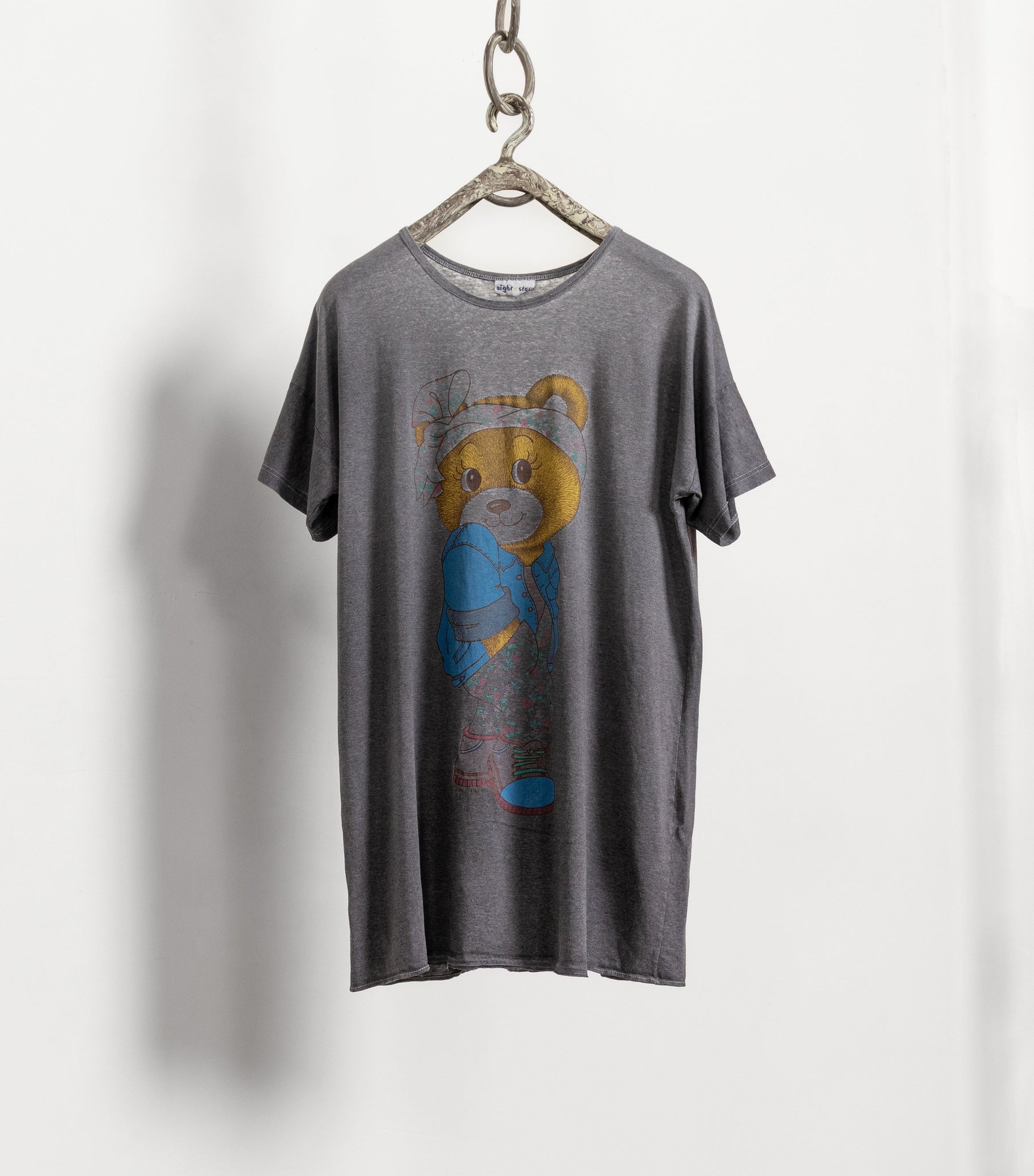 Gray t-shirt with a bear graphic on a hanger against a white background
