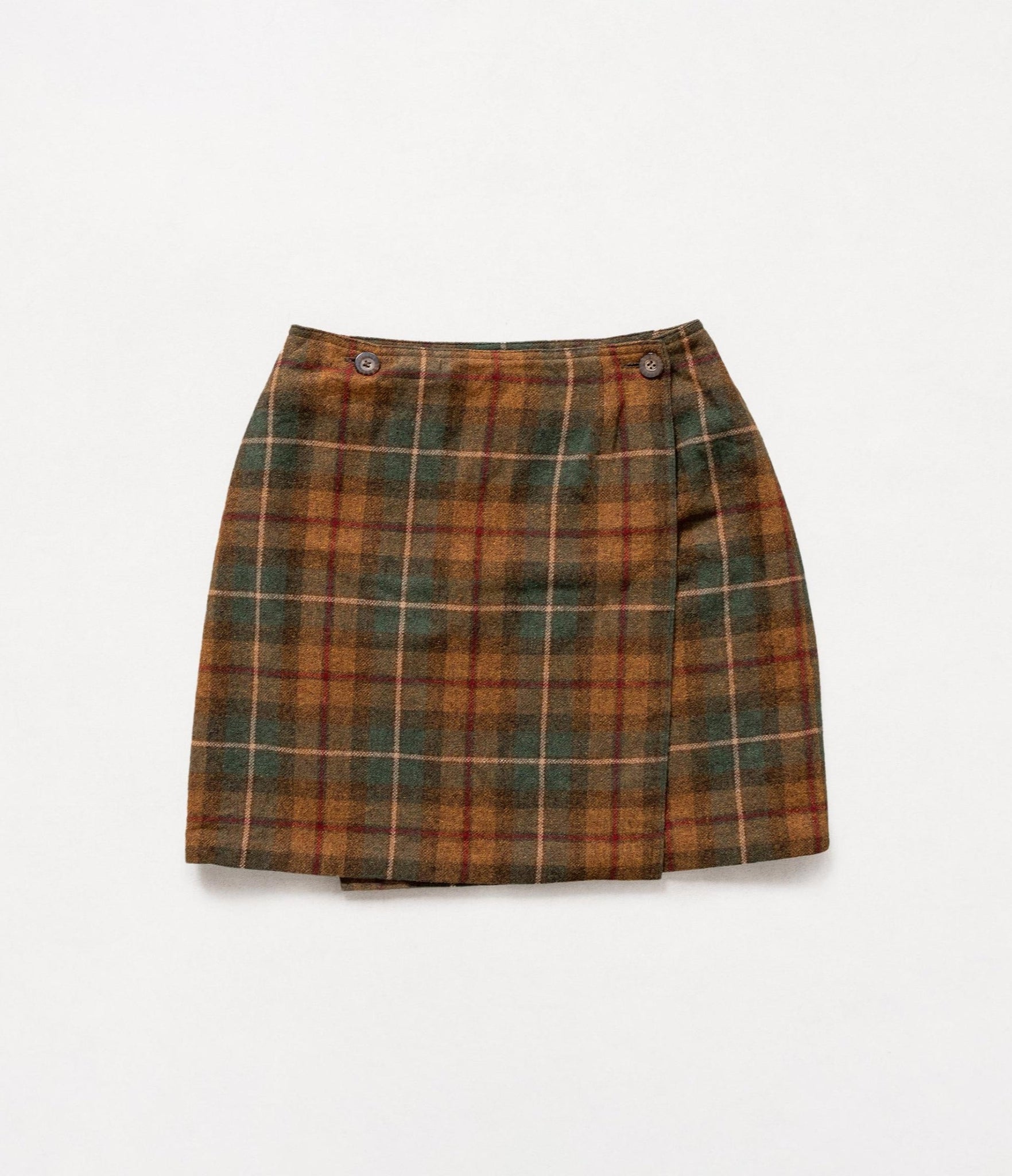 Plaid skirt with brown and green pattern on a white background