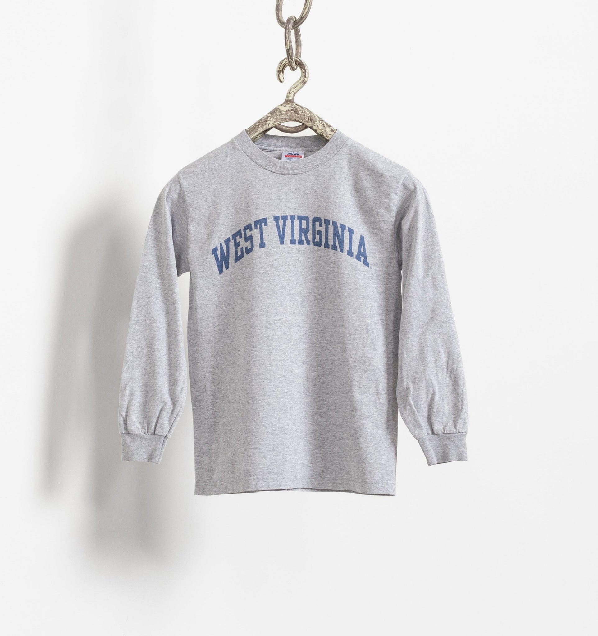 Gray sweatshirt with 'West Virginia' text on a hanger against a white background
