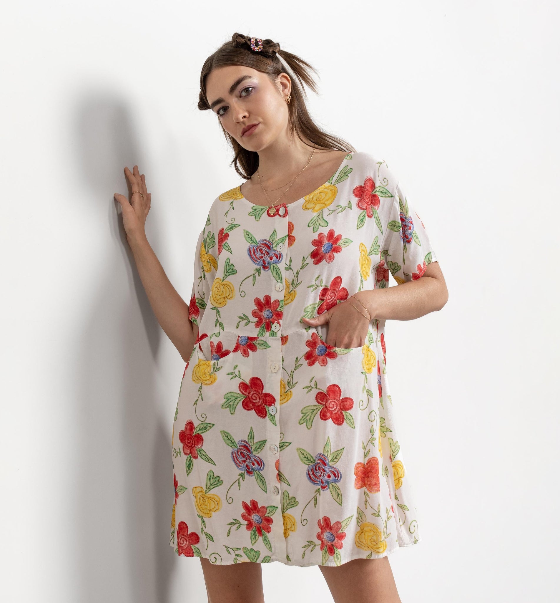 Woman wearing a floral dress against a white background
