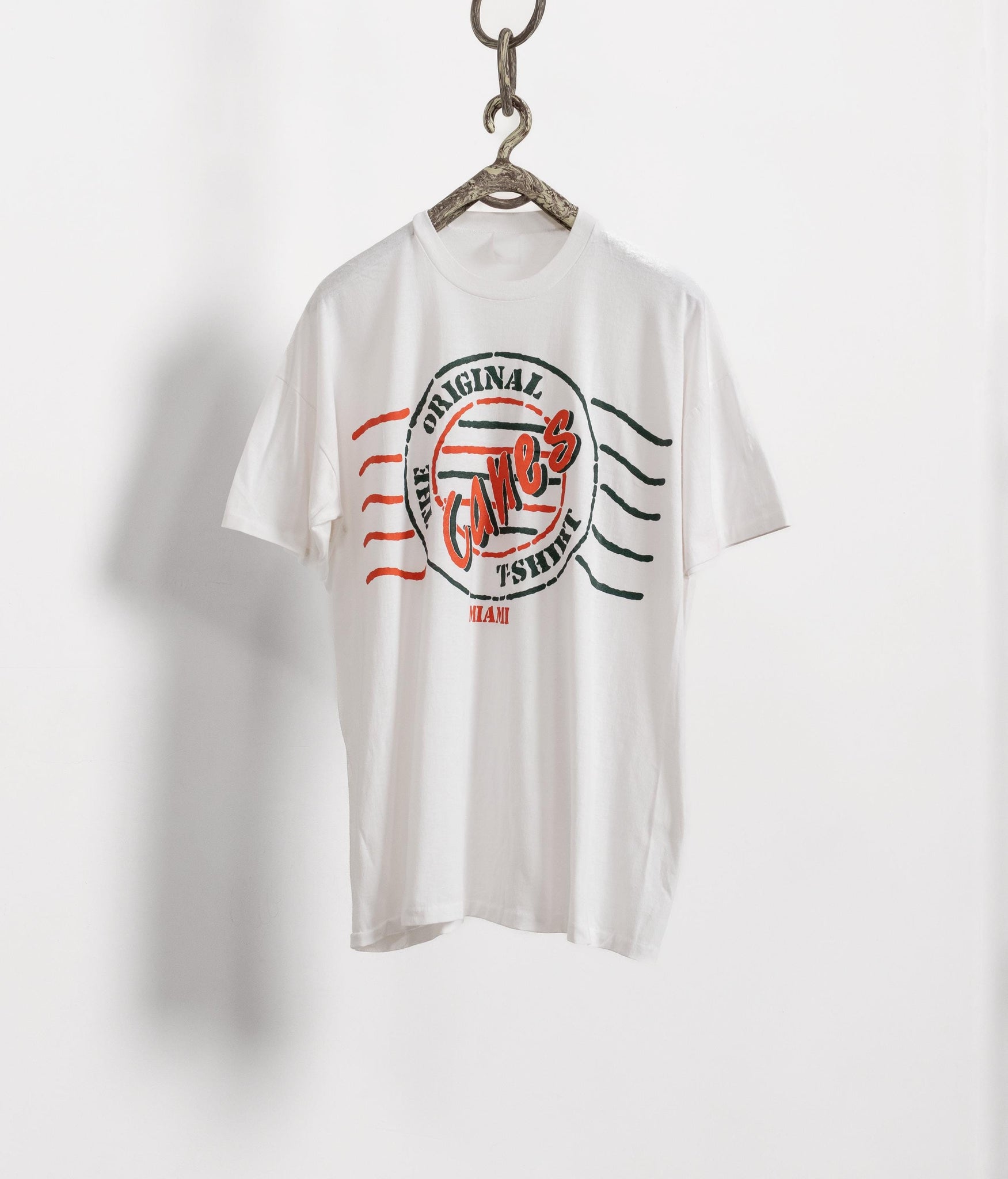 White t-shirt with a graphic design on a white background