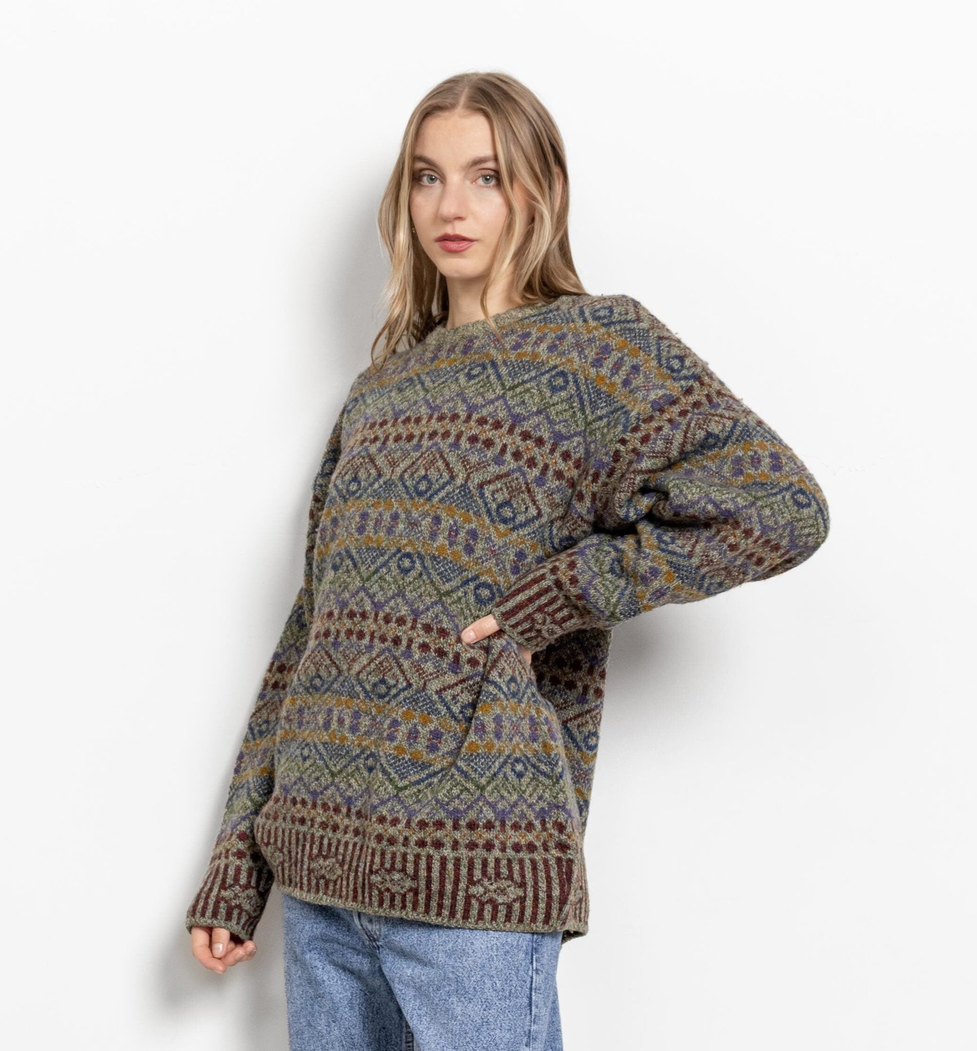 Woman wearing a patterned sweater on a white background