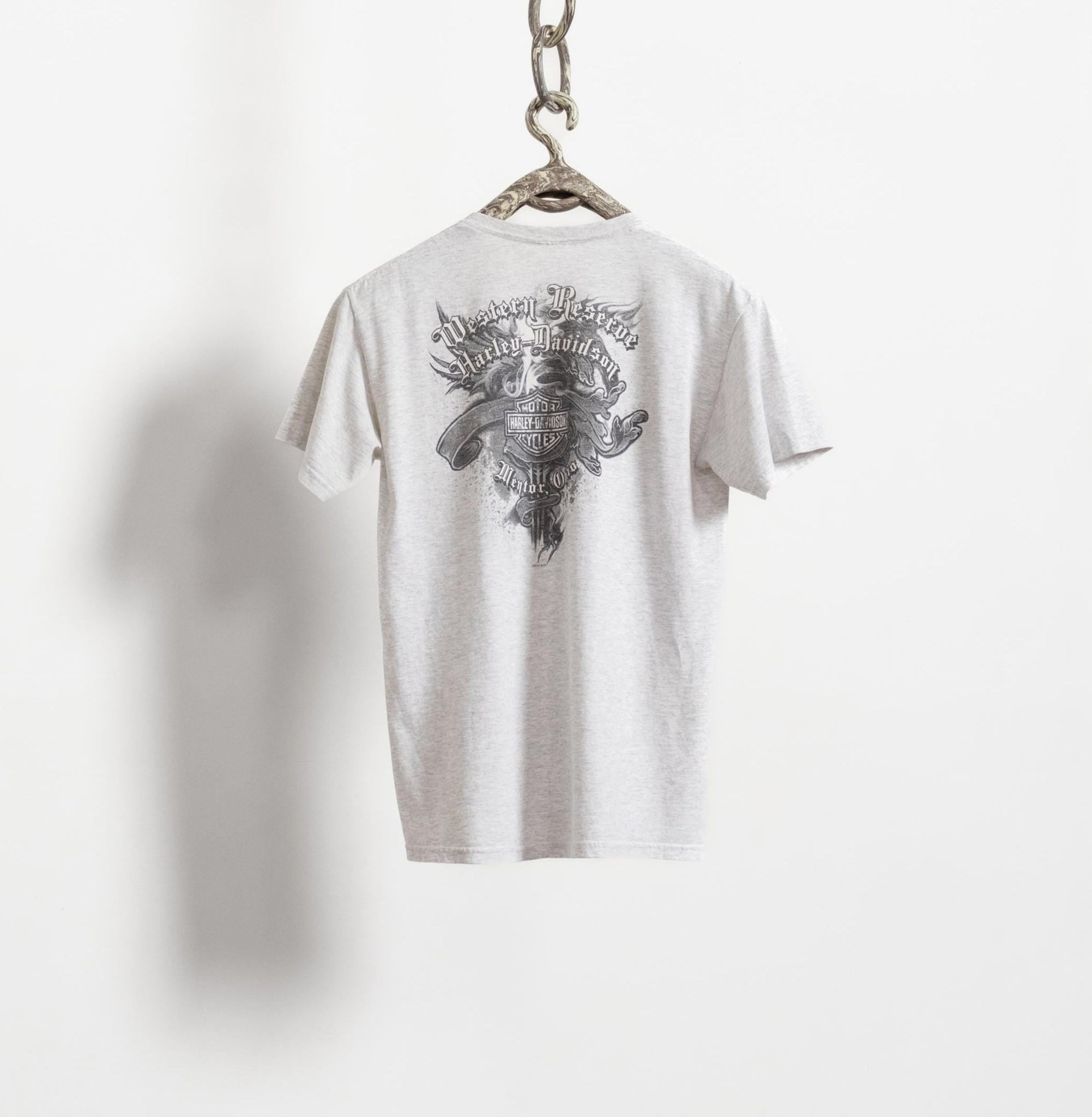 White t-shirt with black graphic design on a white background