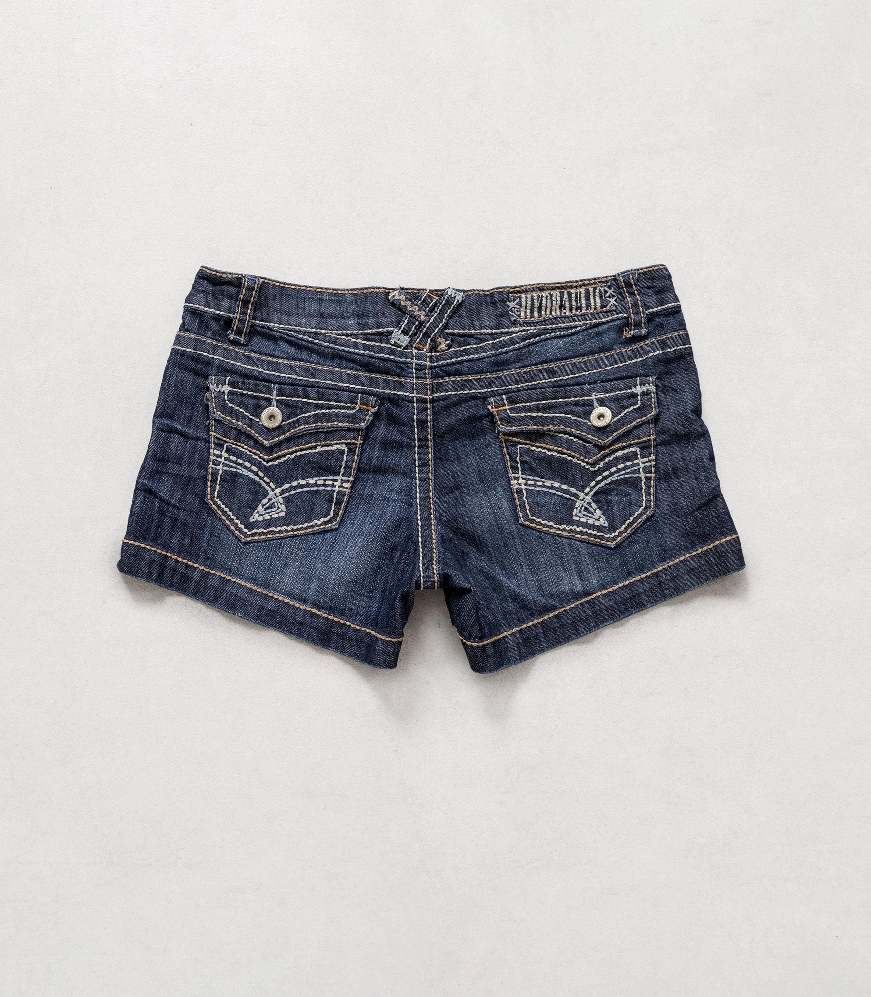 Pair of blue denim shorts on a light gray background