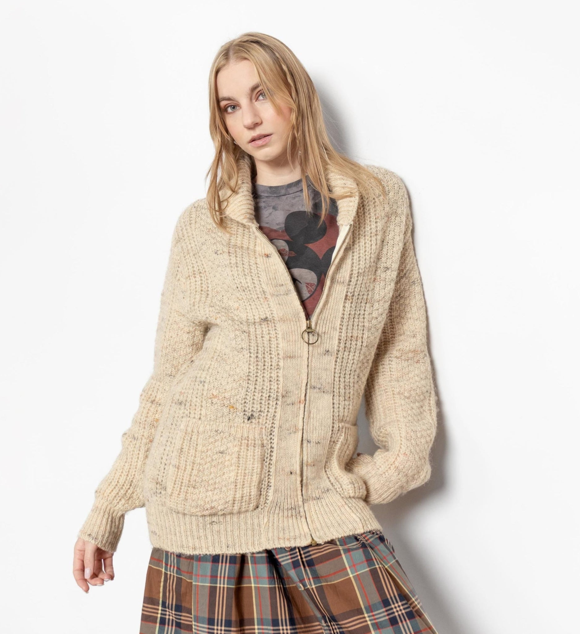 A person wearing a beige vintage Pendleton wool zip-up cardigan with a collared neckline and two square front side pockets.