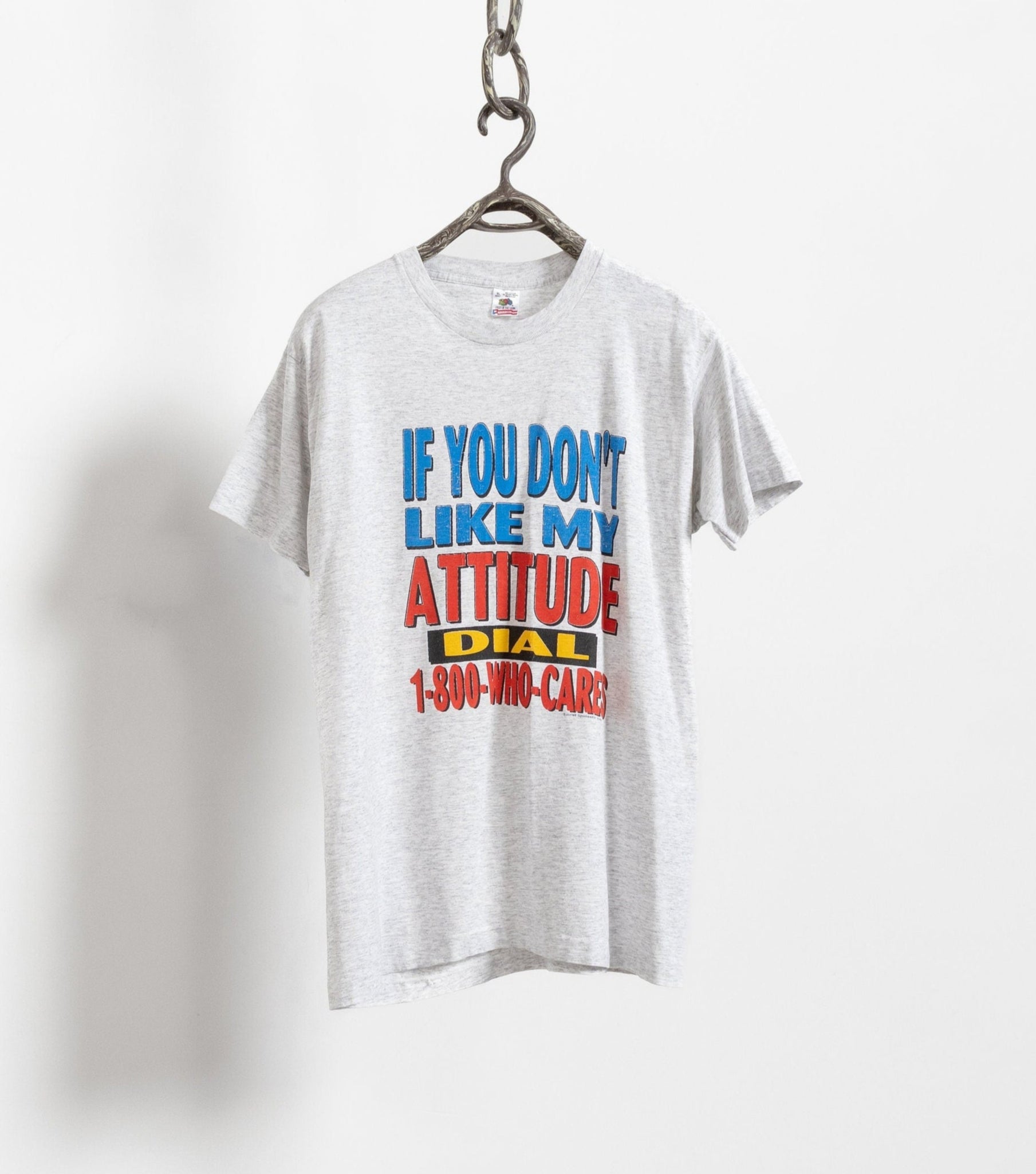 Vintage heather grey oversized short sleeve crew neck t-shirt with text graphic, hanging on a hanger.