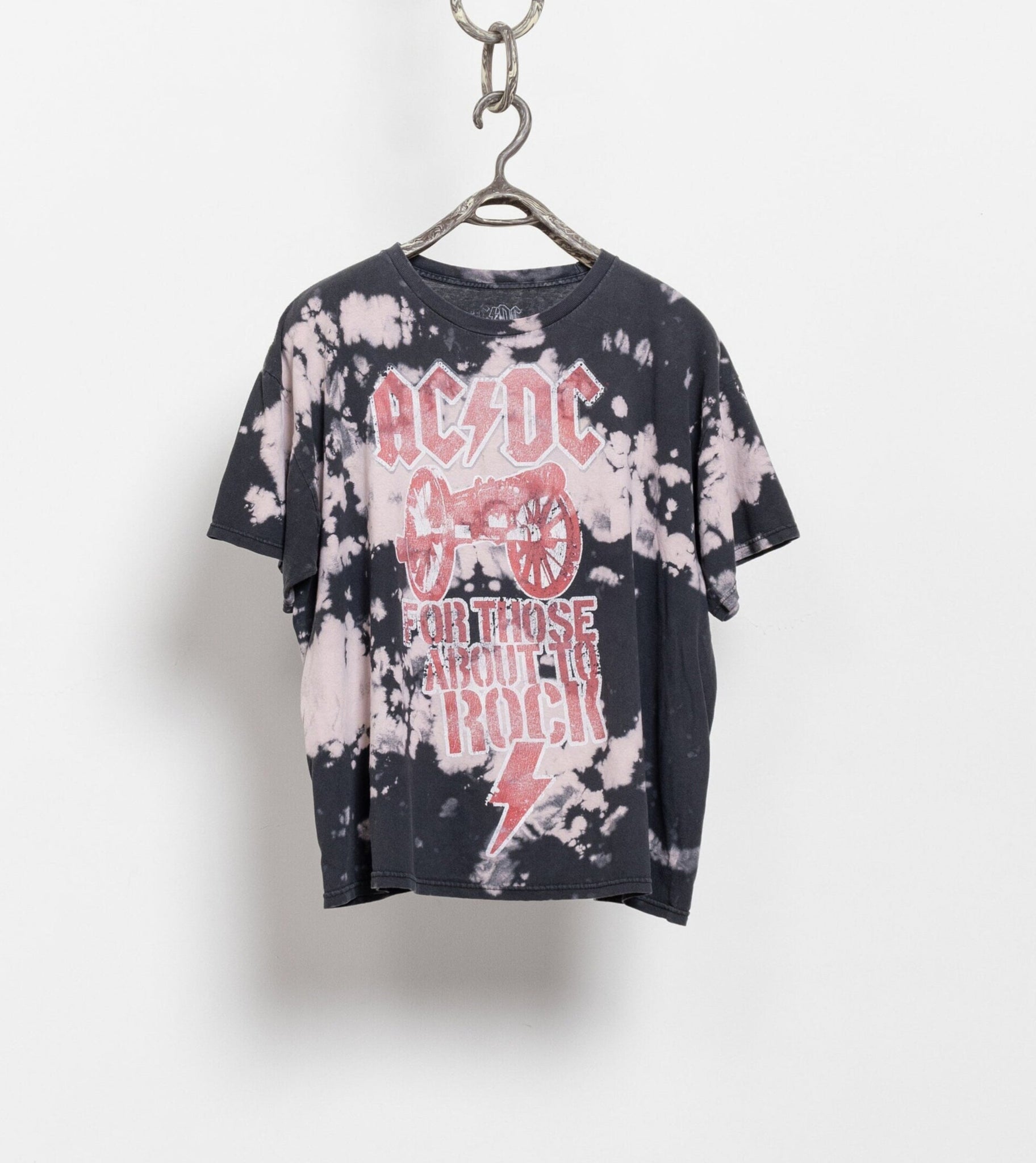 Bleached t-shirt with AC/DC logo and text on a hanger against a white background
