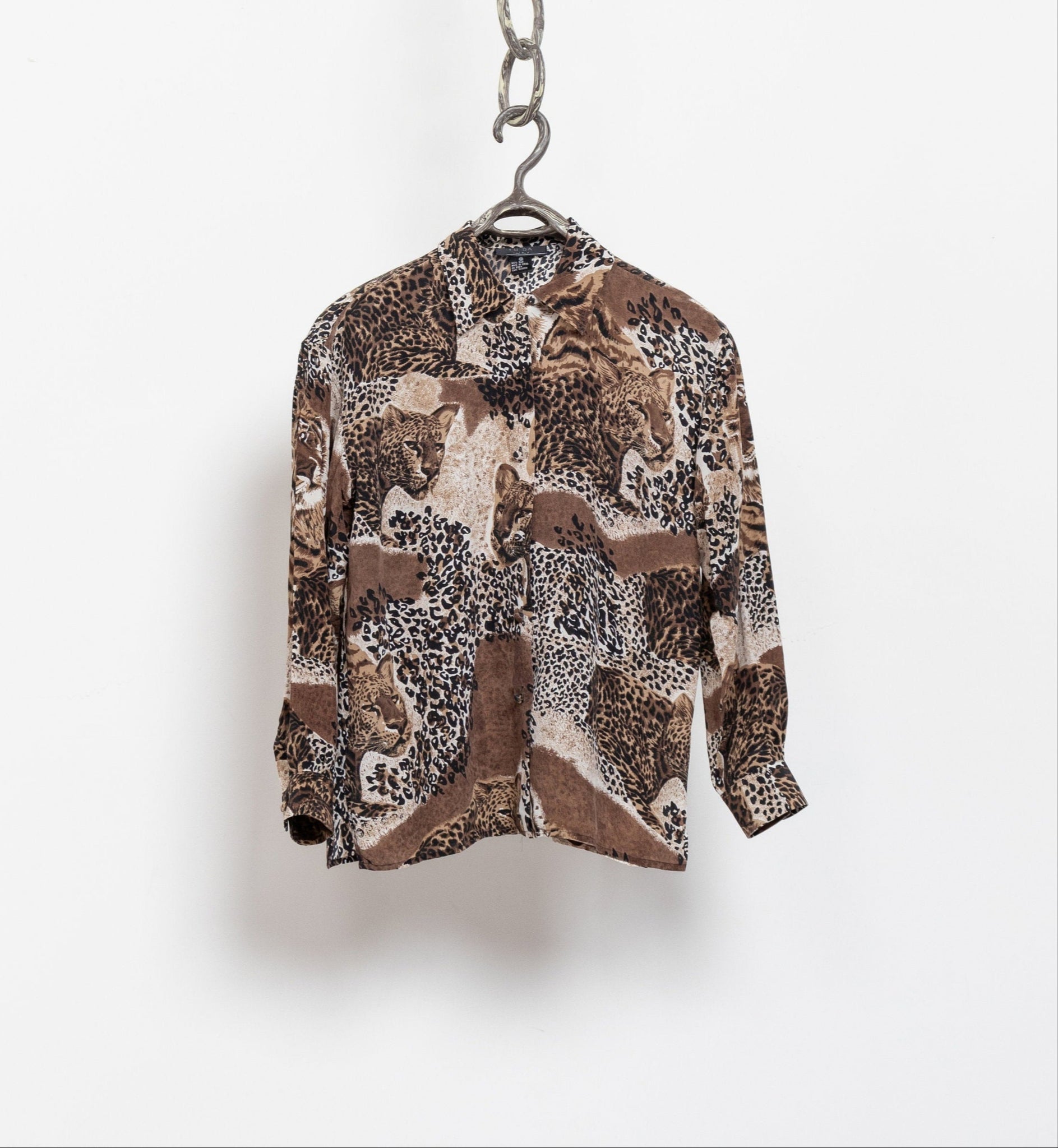 Patterned shirt on a hanger against a white background