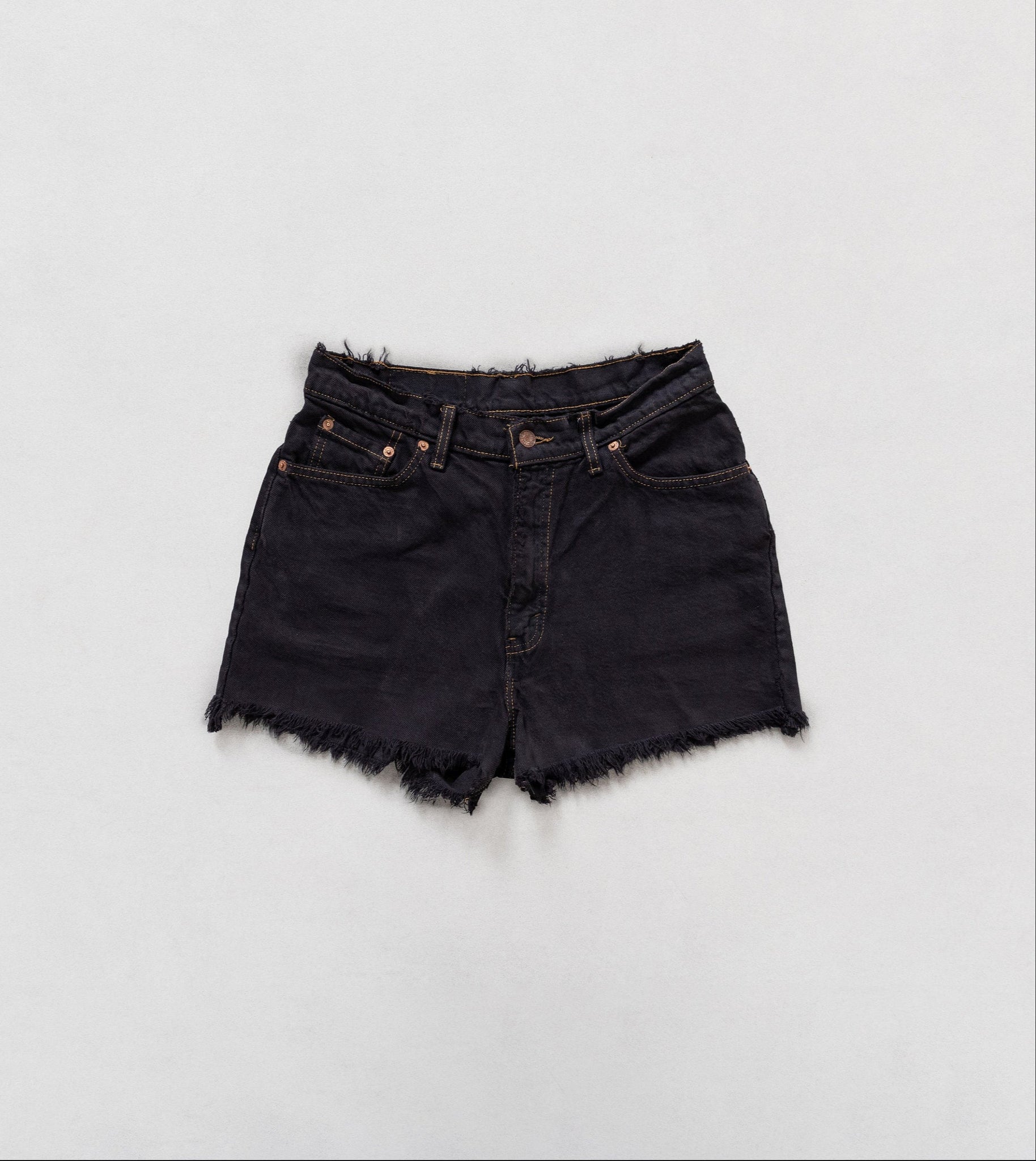 Black denim shorts on a white background