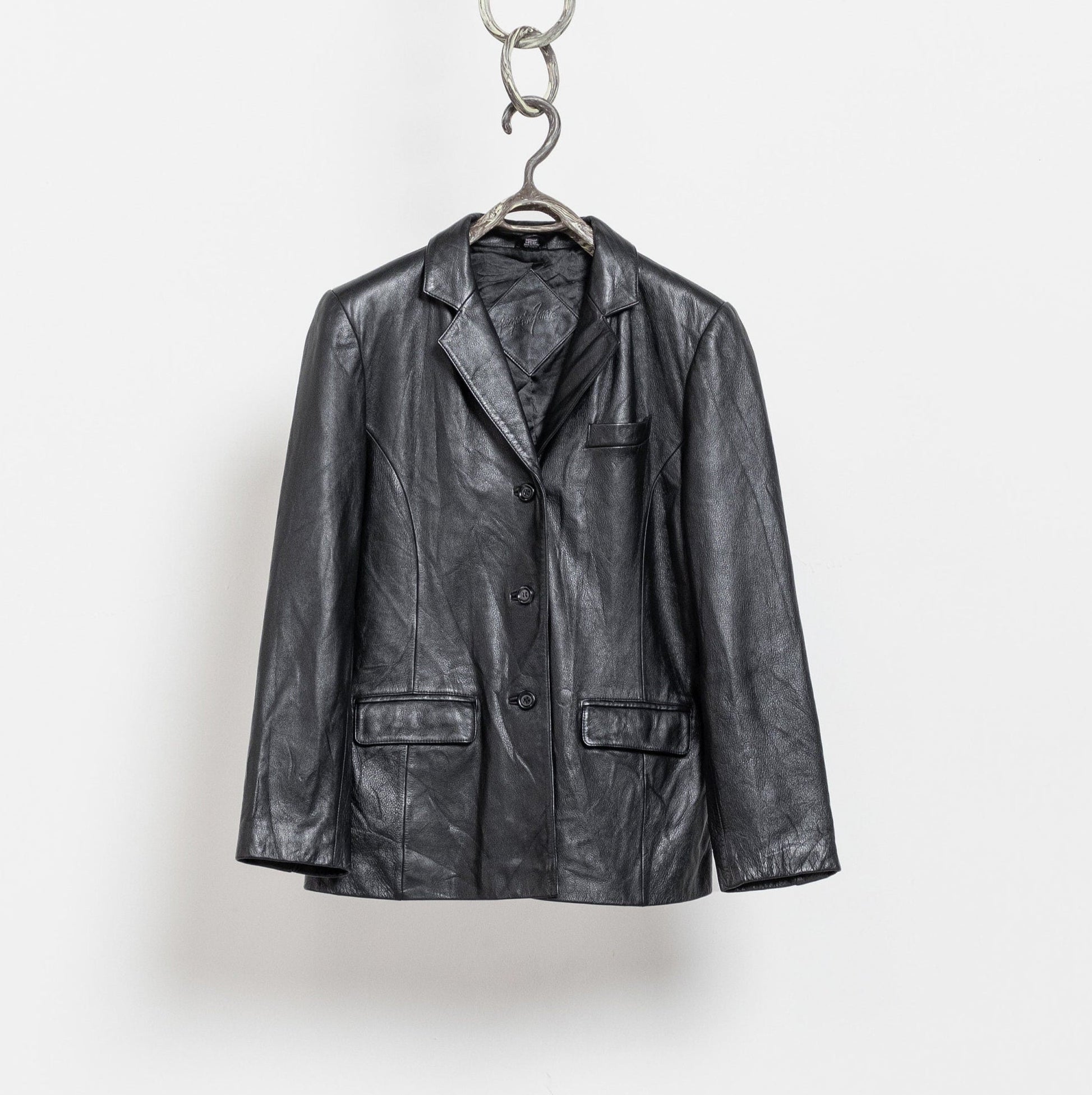 Black leather jacket hanging on a white background
