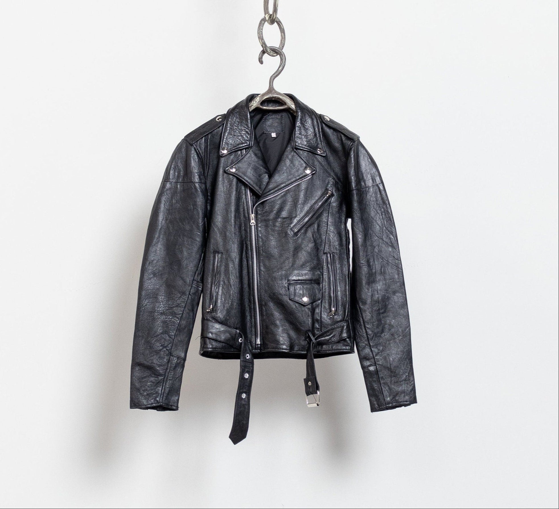 Black leather jacket hanging on a white background