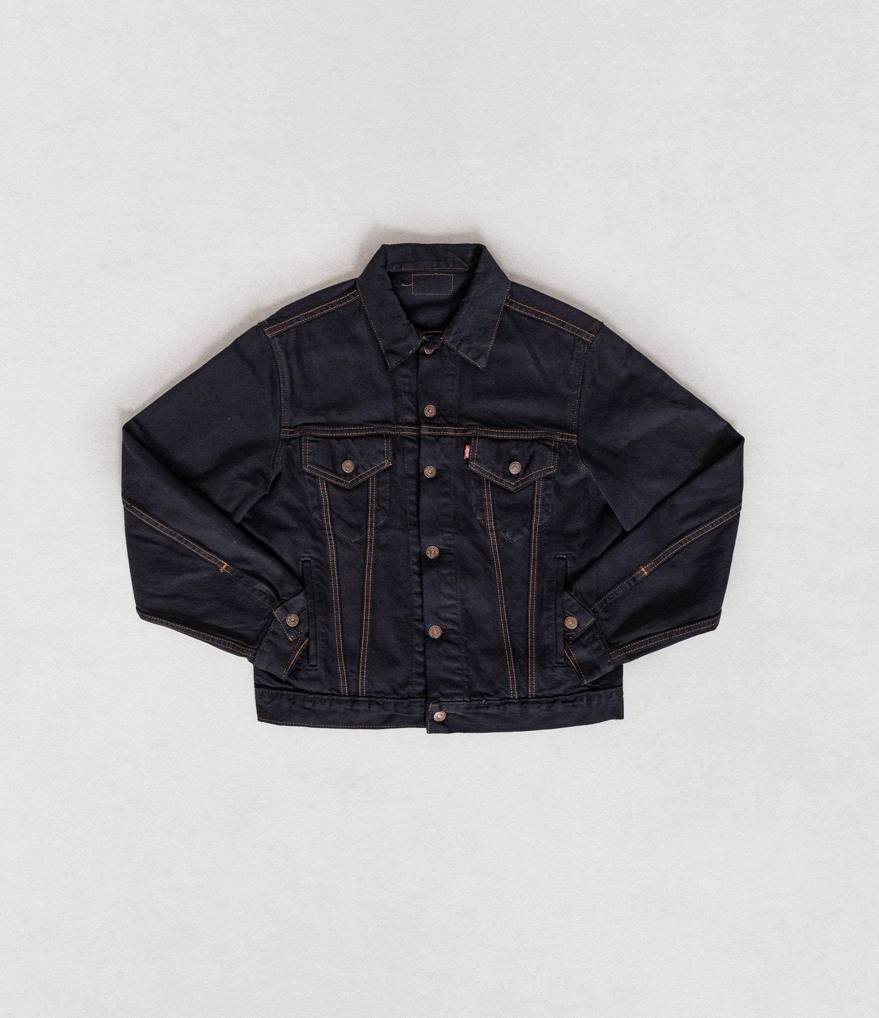 Black denim jacket on a white background