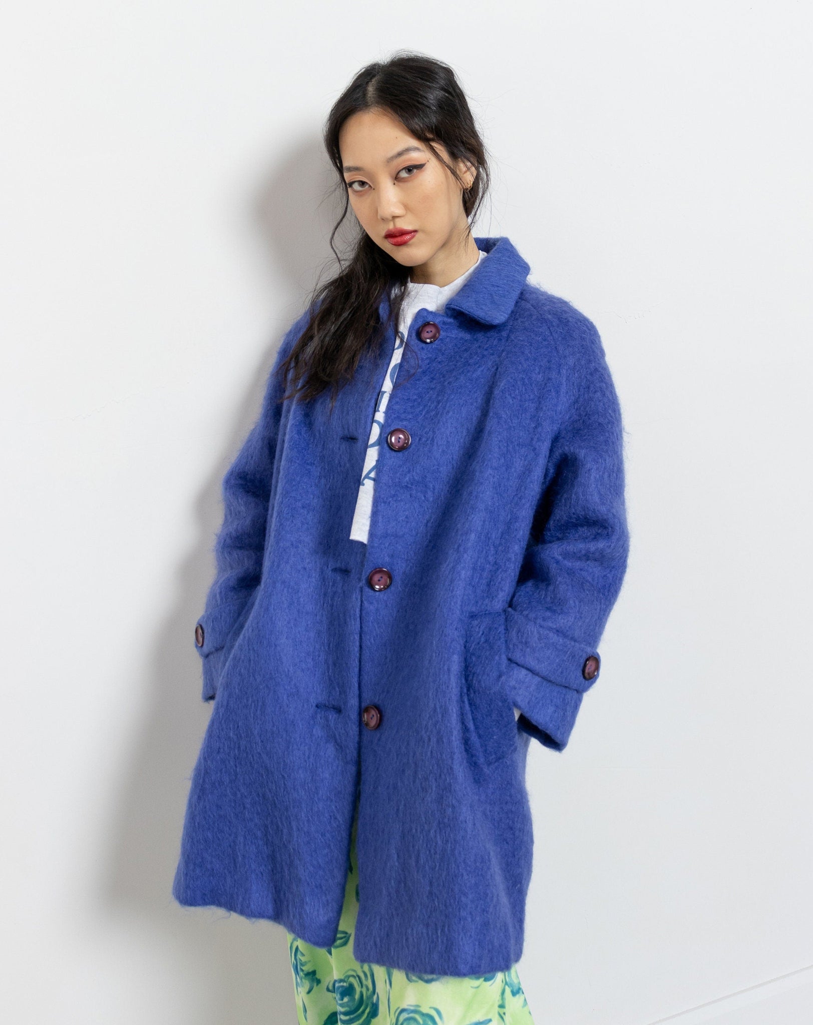 Woman wearing a blue coat on a white background