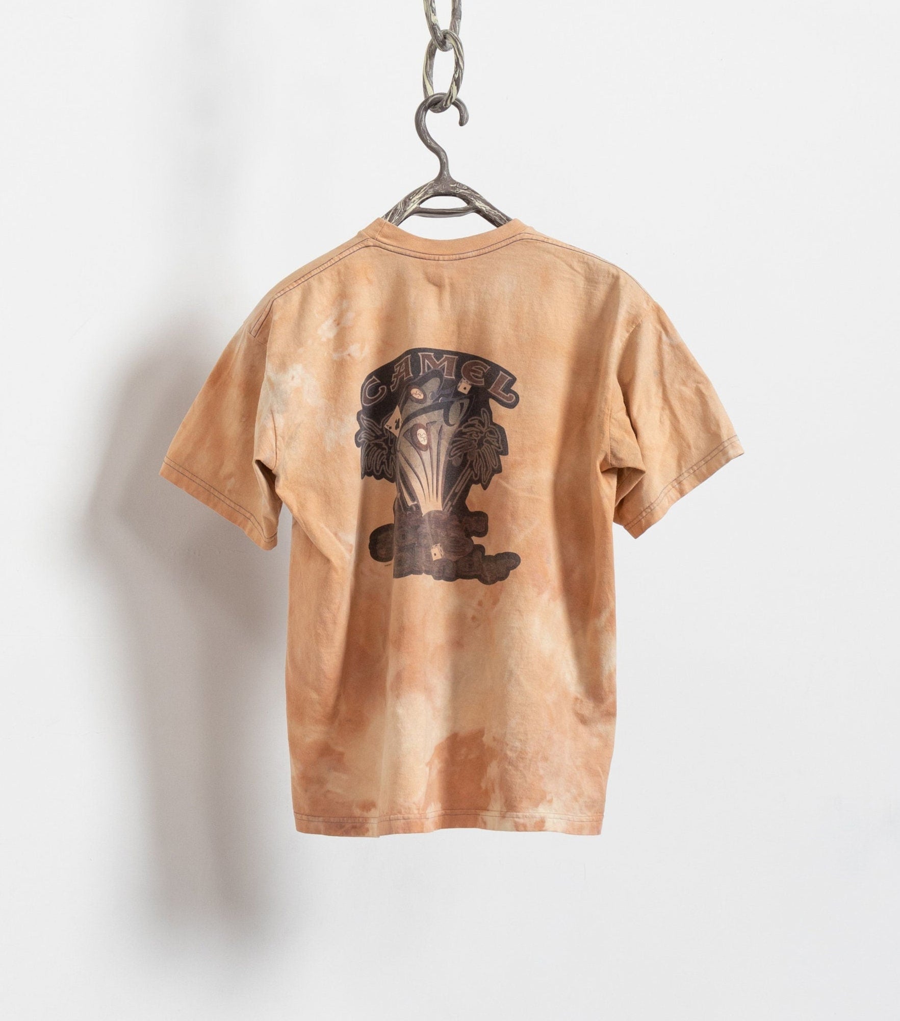 Brown t-shirt with a graphic design on a hanger against a white background