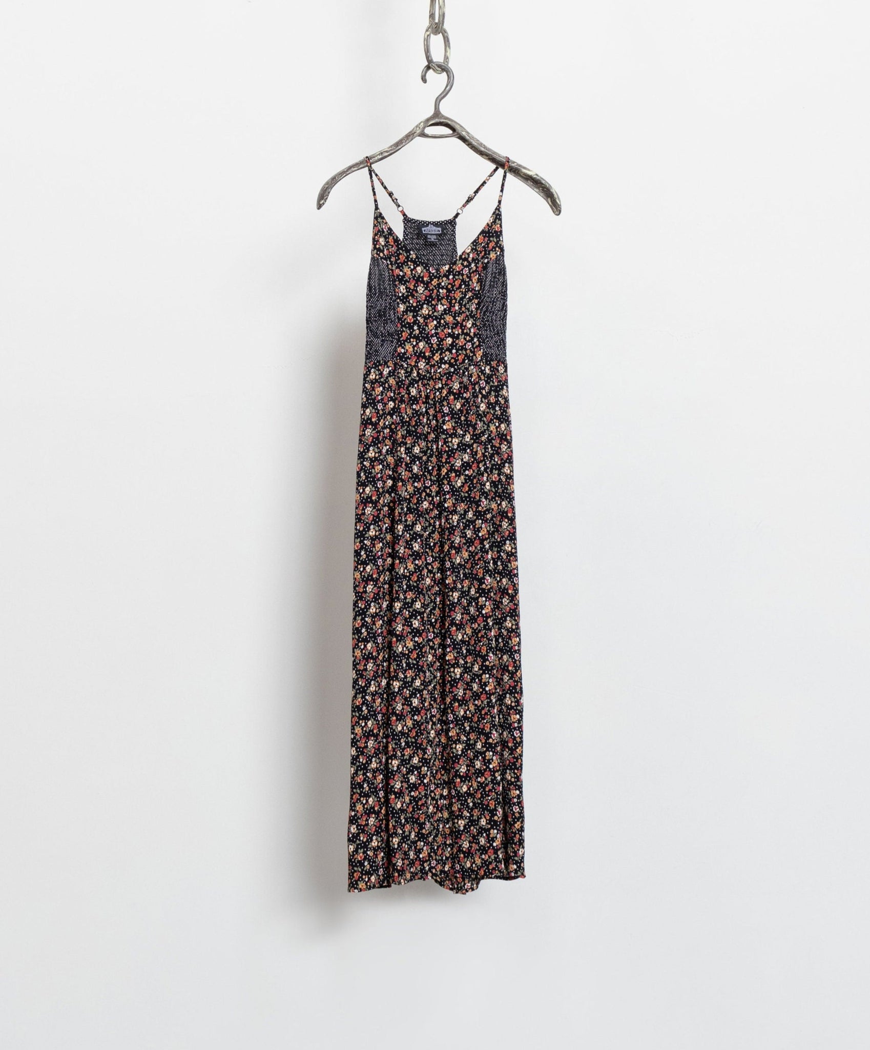 A vintage 90's ditzy floral maxi dress with spaghetti straps and a long side slit, displayed on a hanger against a white background.