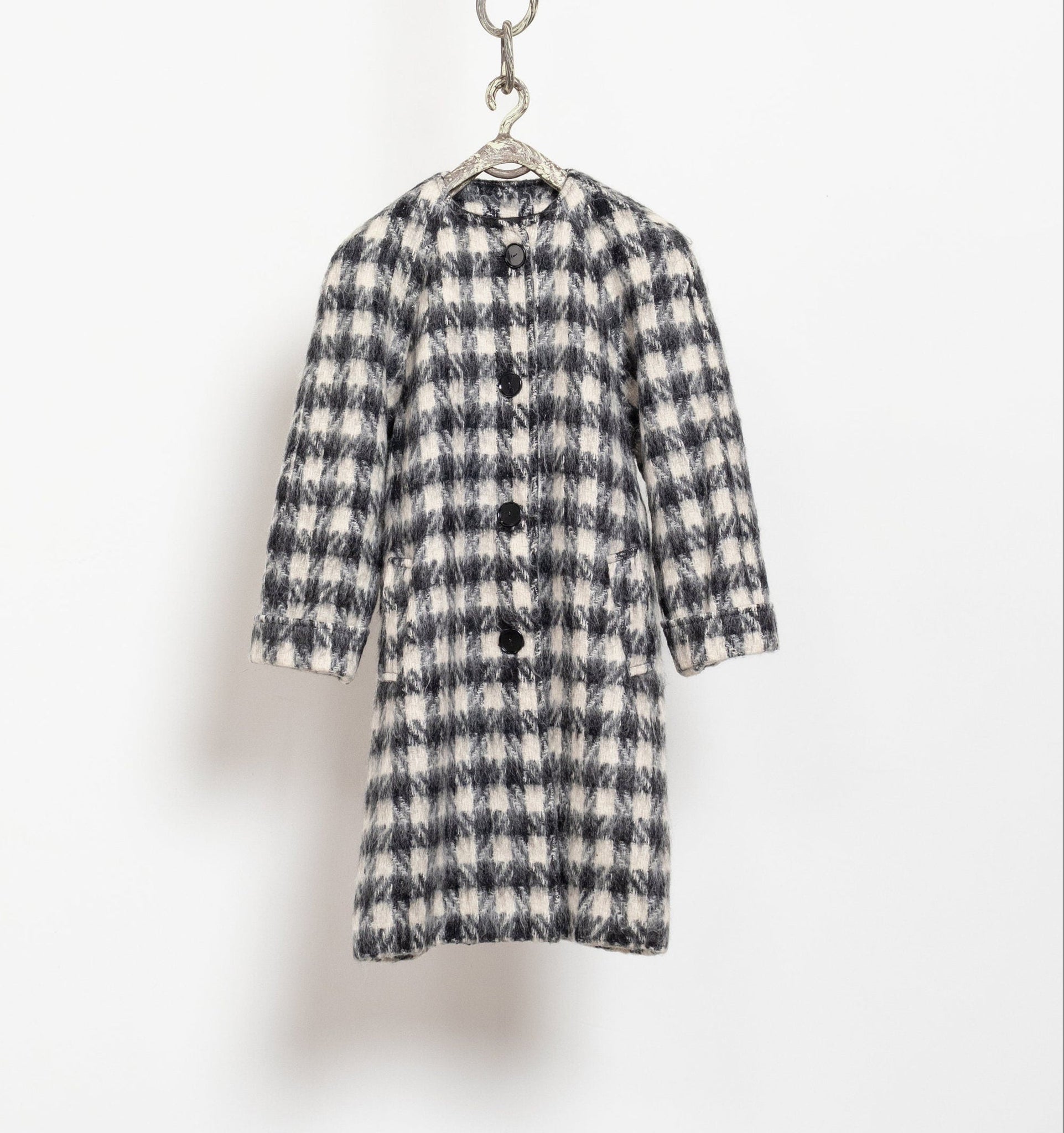 Plaid coat hanging on a white background