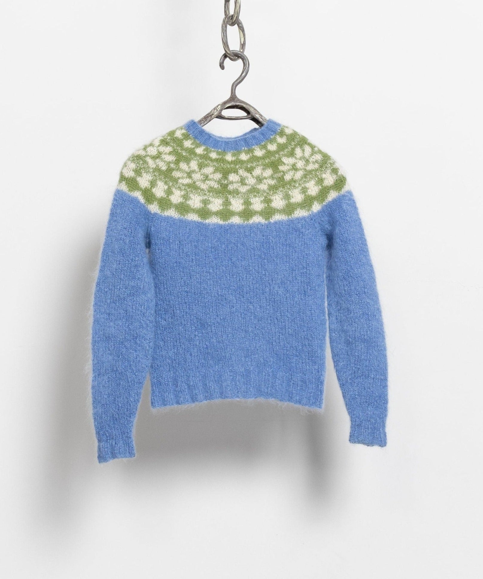 A vintage 90's blue and green Icelandic patterned wool pullover sweater displayed on a hanger.