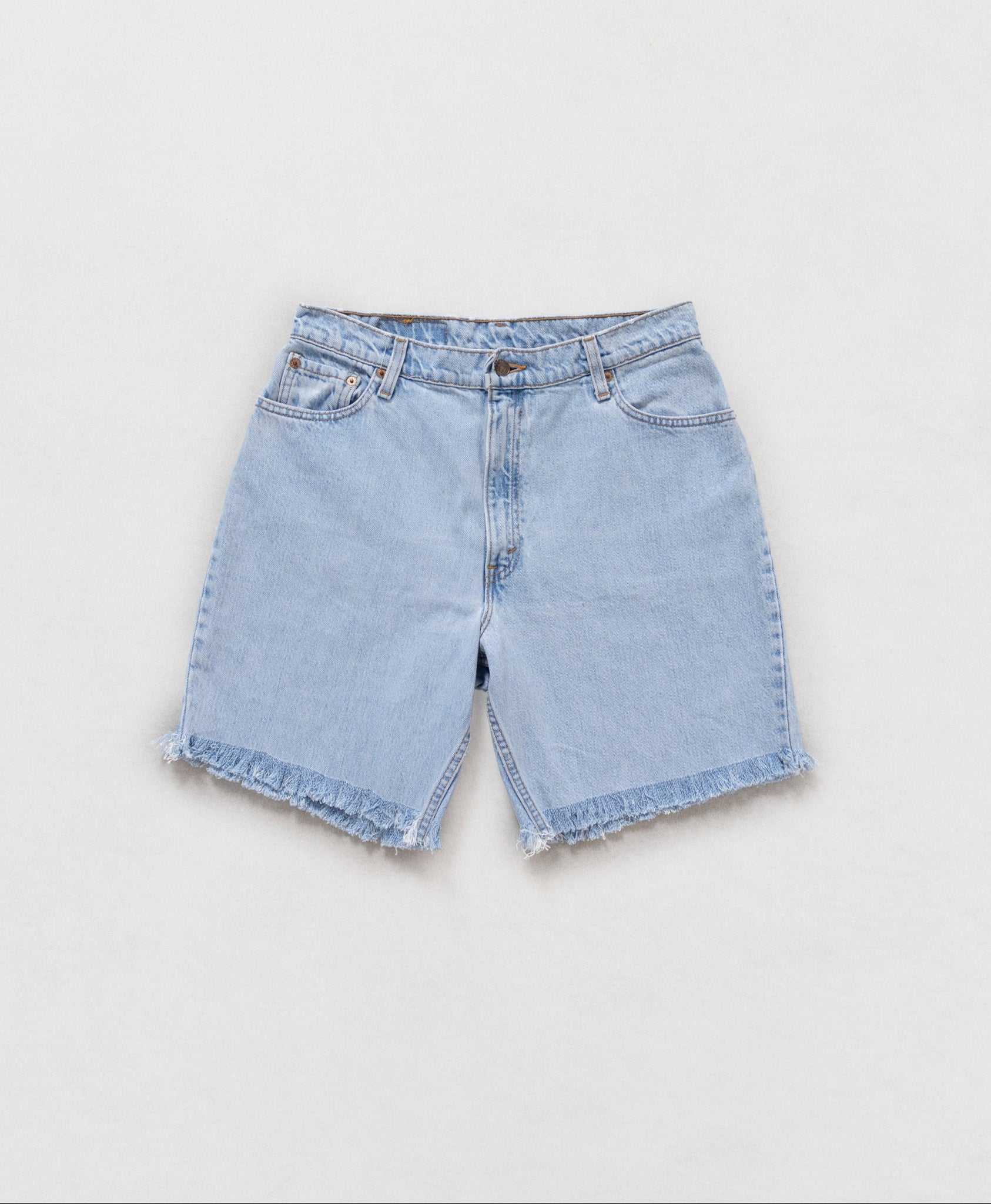 Light blue denim shorts on a white background