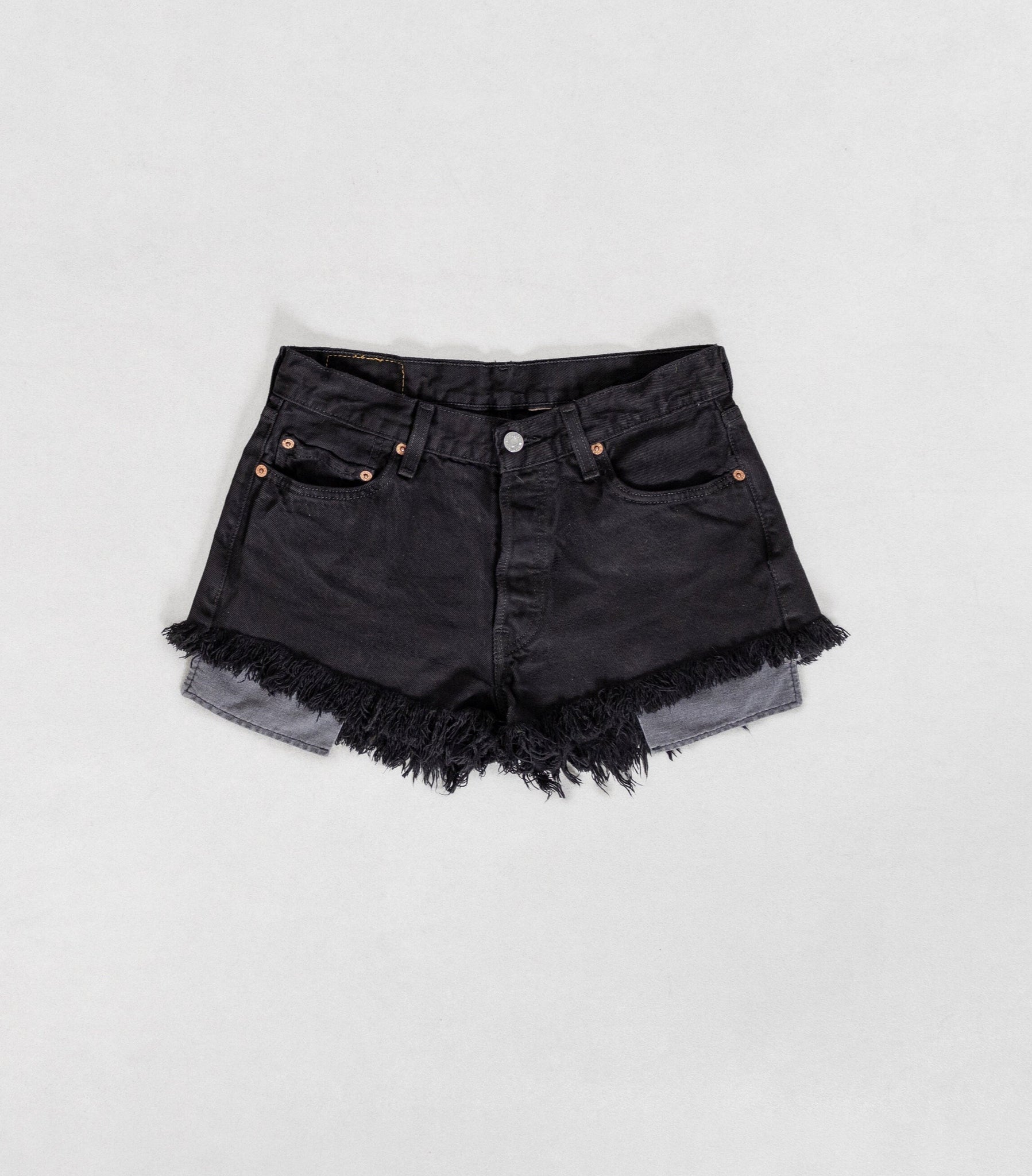 Black denim shorts with frayed edges on a white background