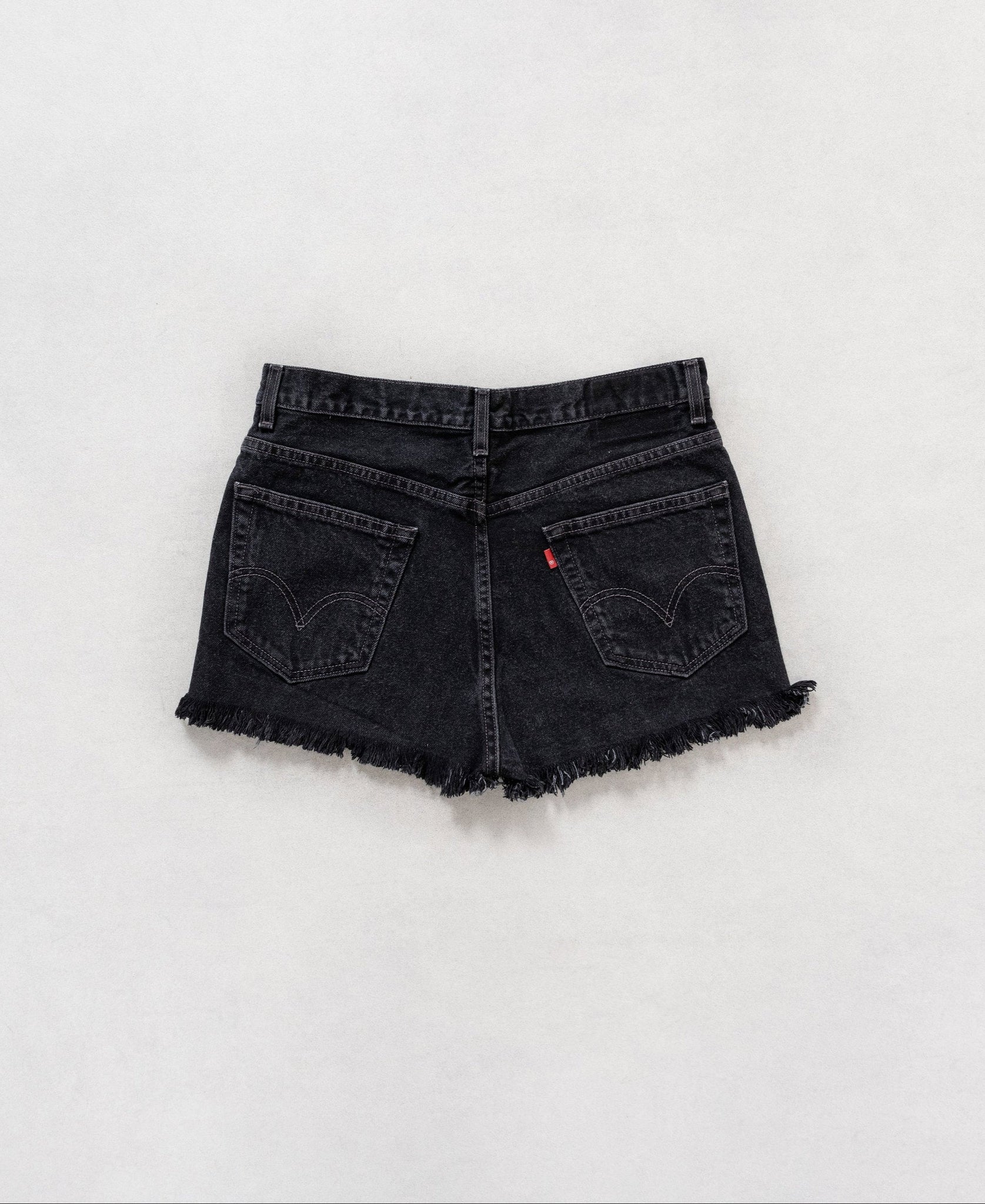 Black denim shorts on a white background