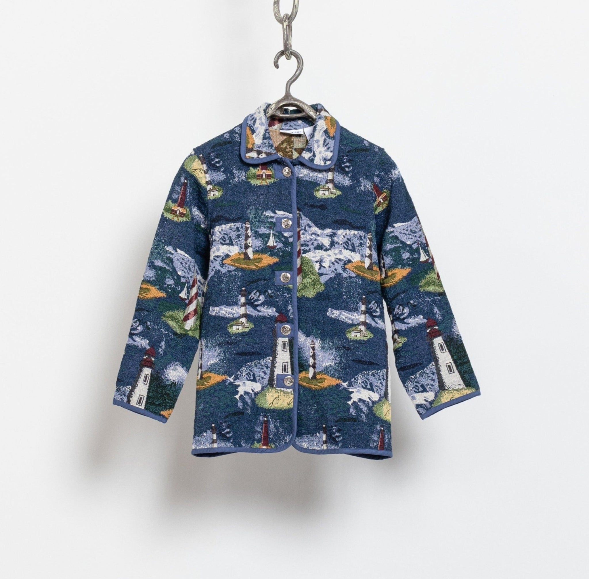 Jacket with lighthouse pattern on a hanger against a white background