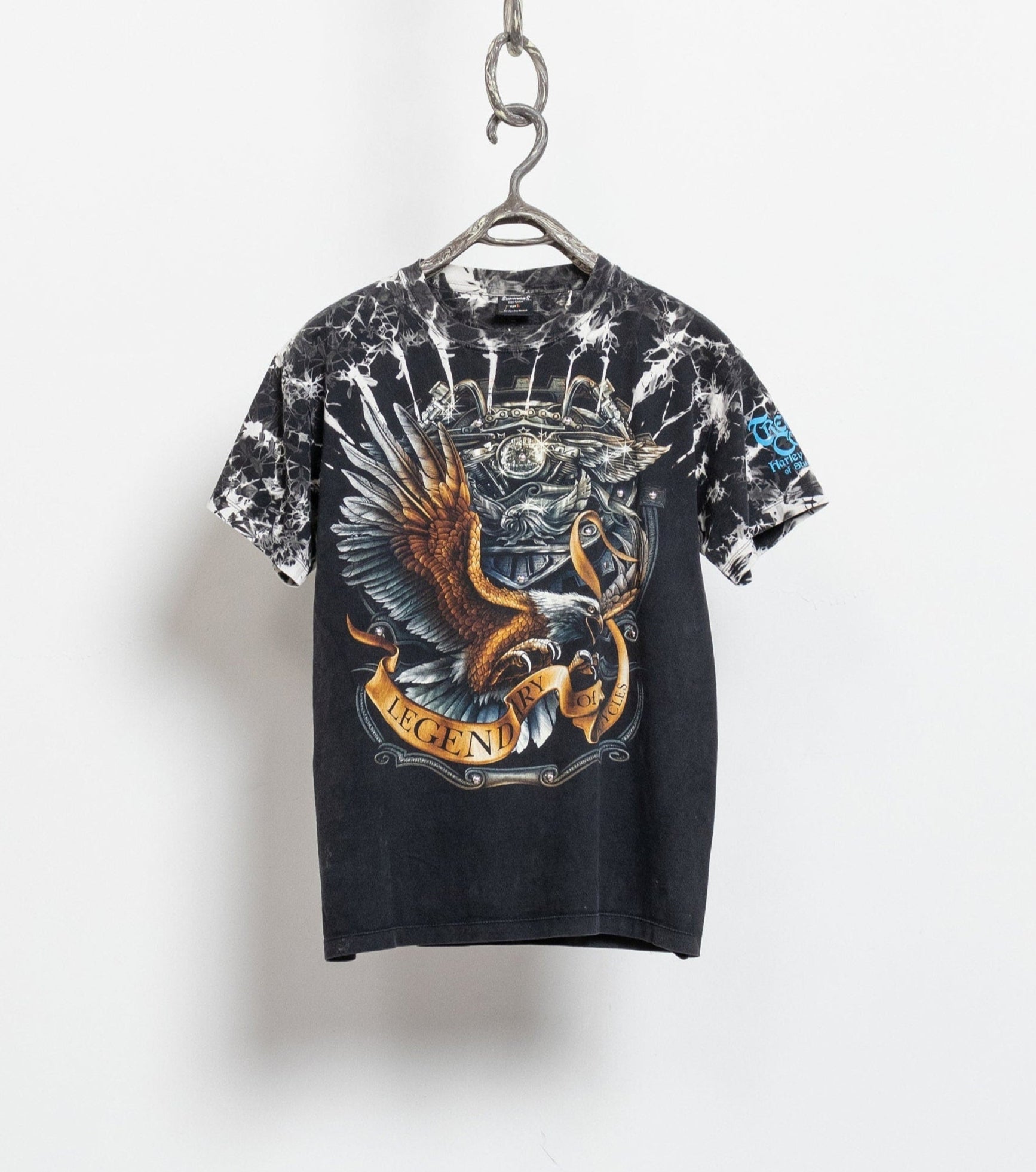 Black t-shirt with colorful graphic design on a white background