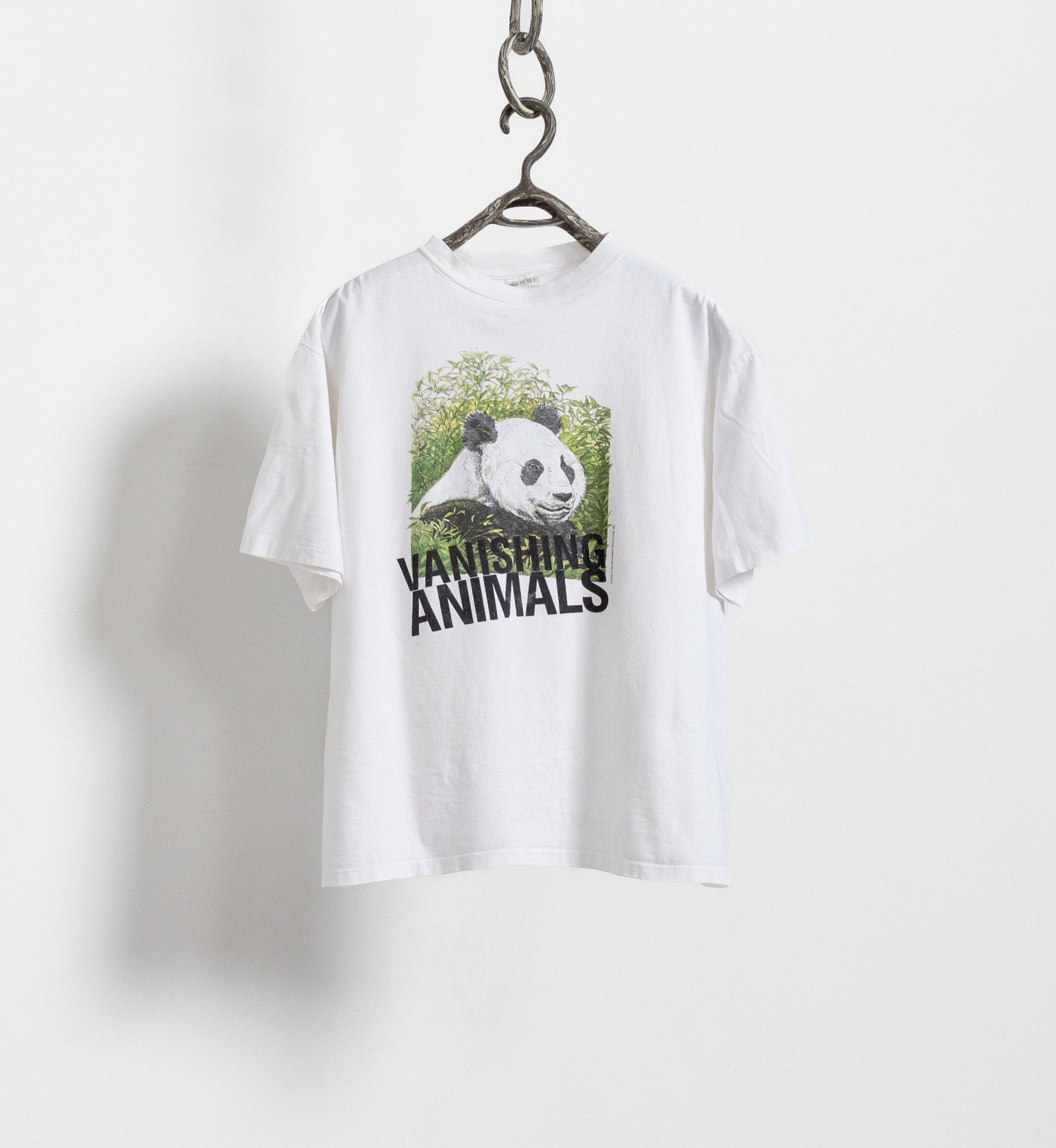 White t-shirt with panda graphic and 'Vanishing Animals' text on a hanger against a white background