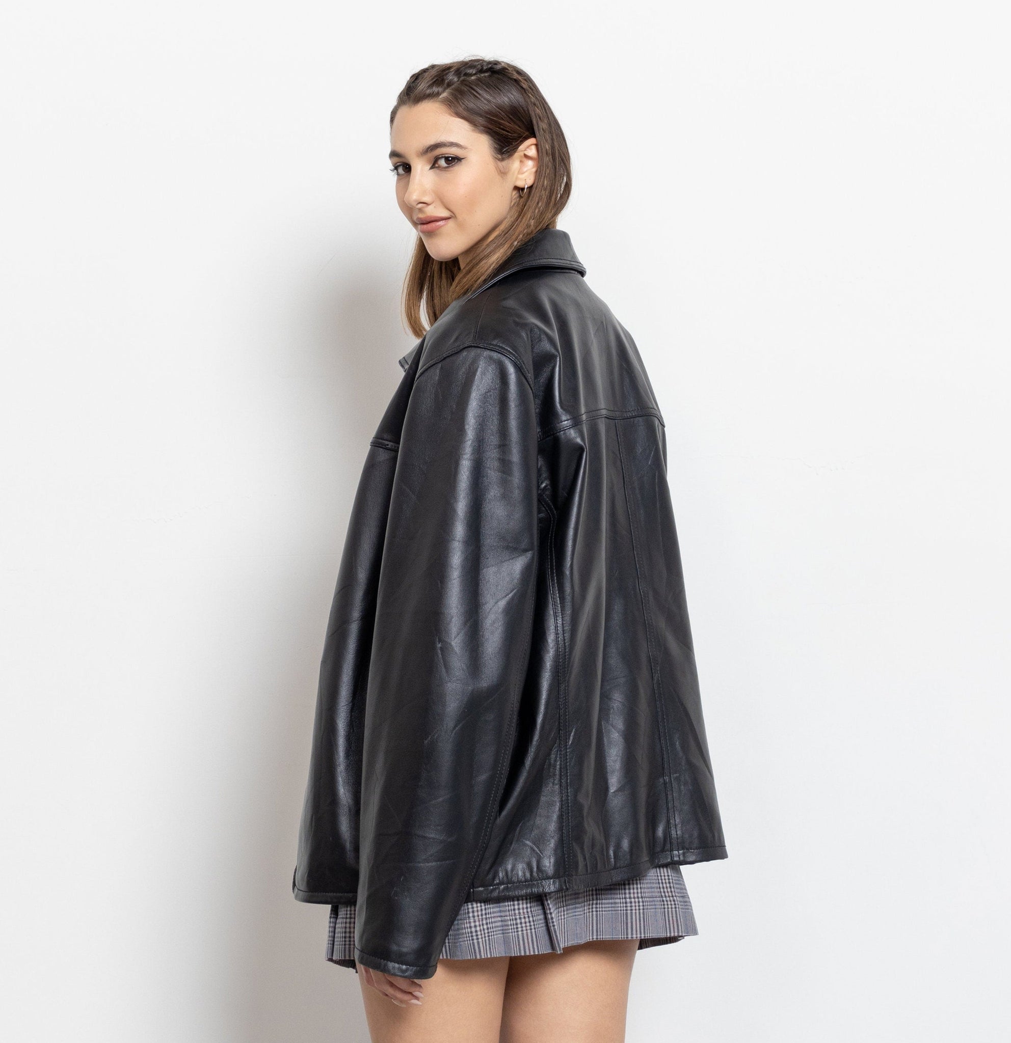 Woman wearing a black leather jacket on a white background