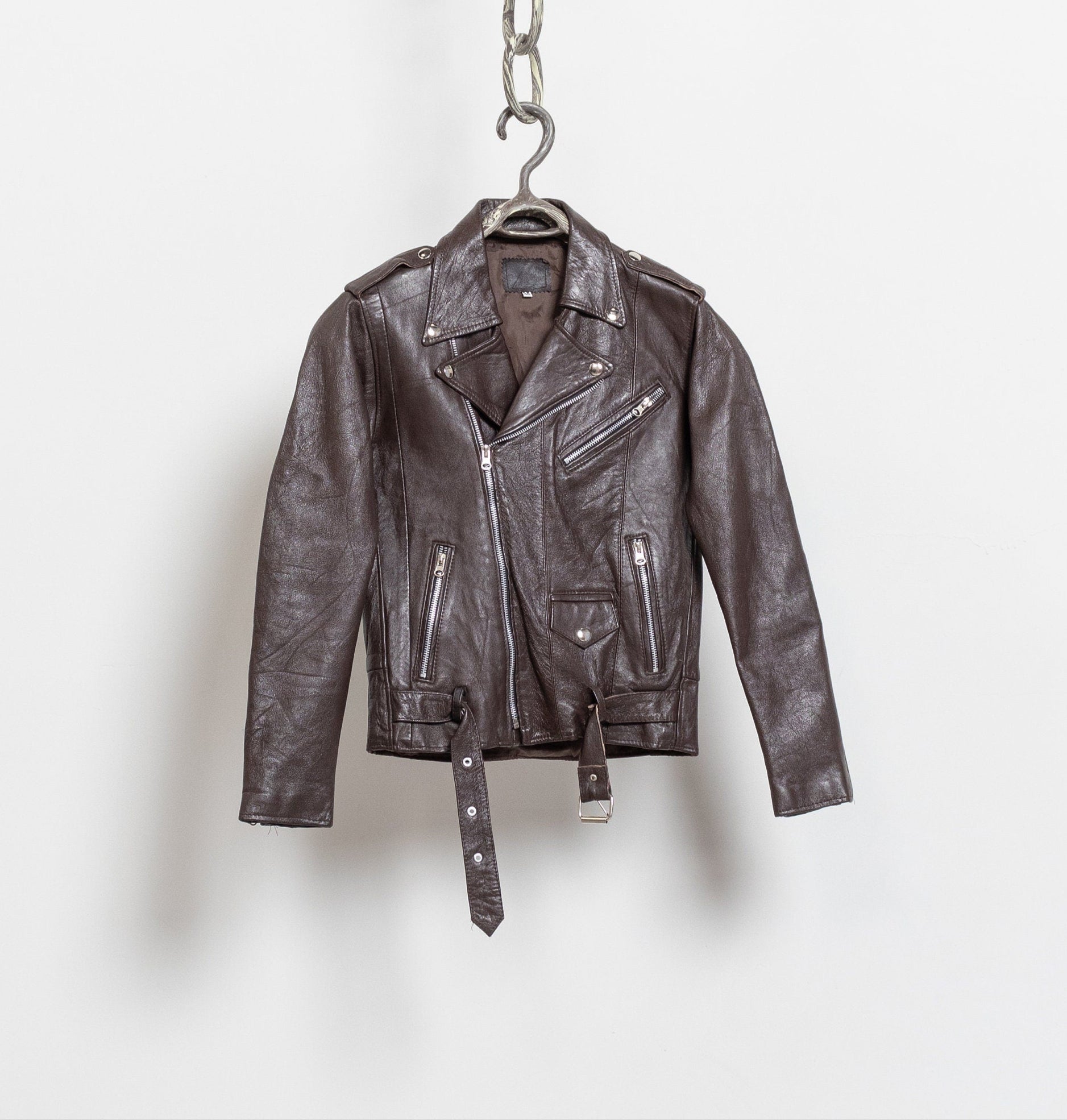 Brown leather jacket on a hanger against a white background