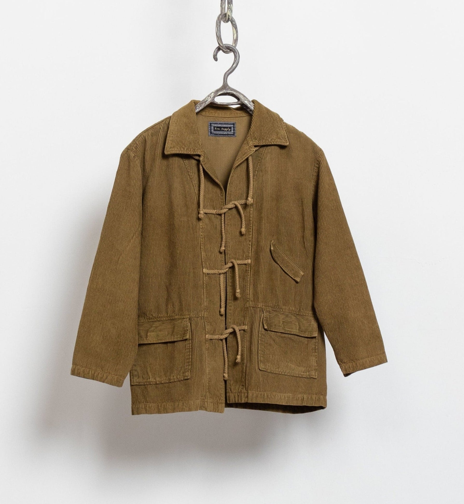 Brown jacket on a hanger against a white background