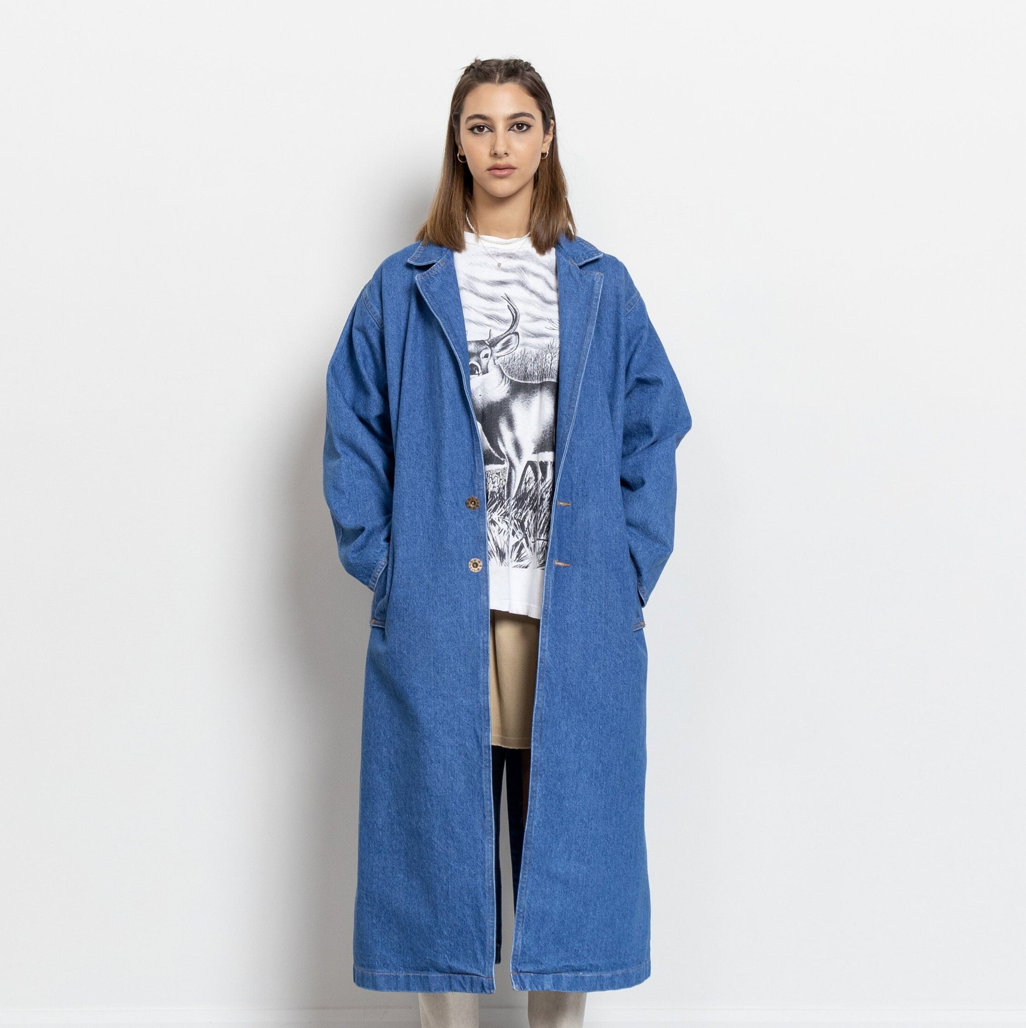 Woman wearing a blue coat on a white background