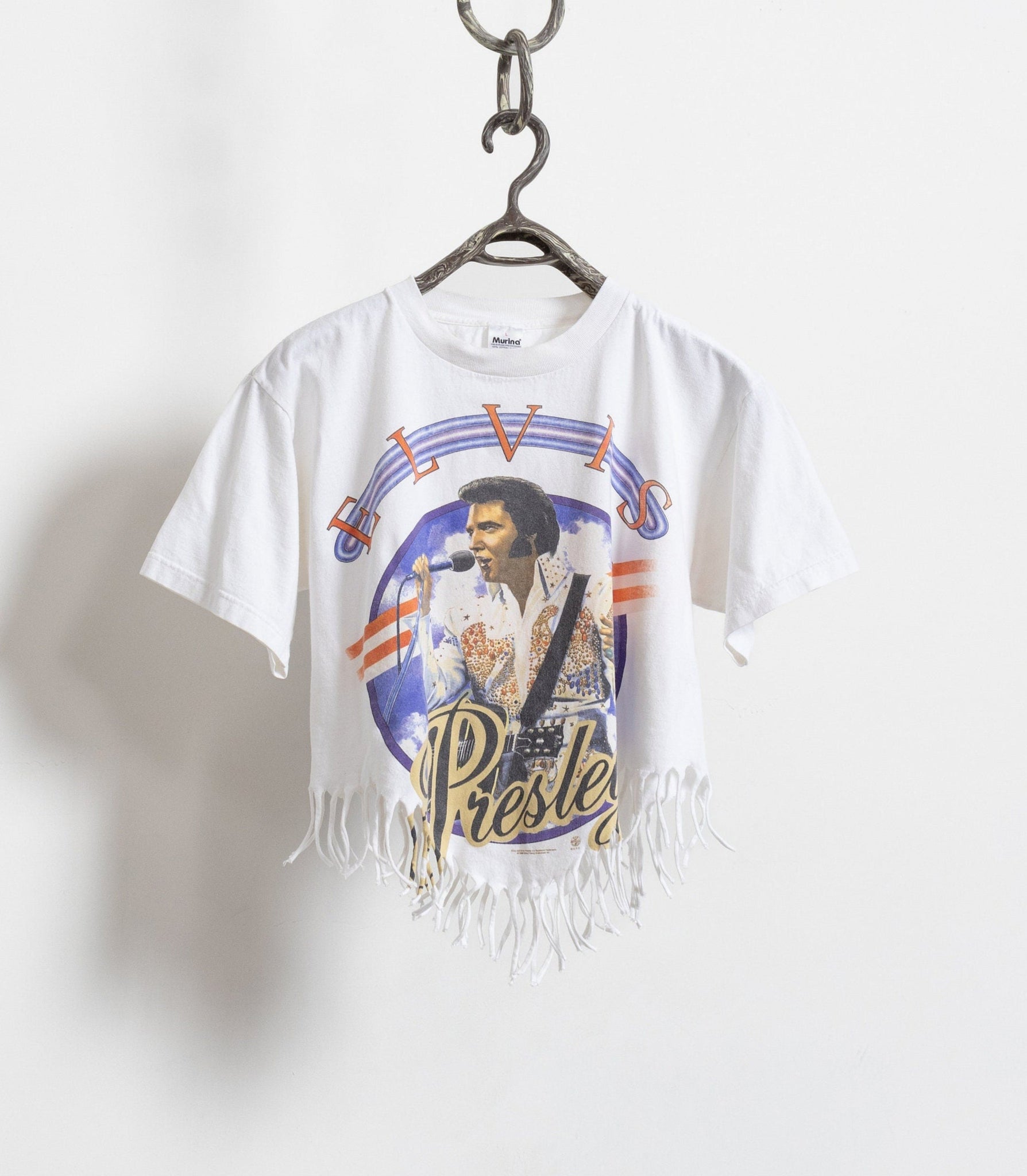 Vintage white t-shirt with a graphic of Elvis Presley and an asymmetrical fringe hem.