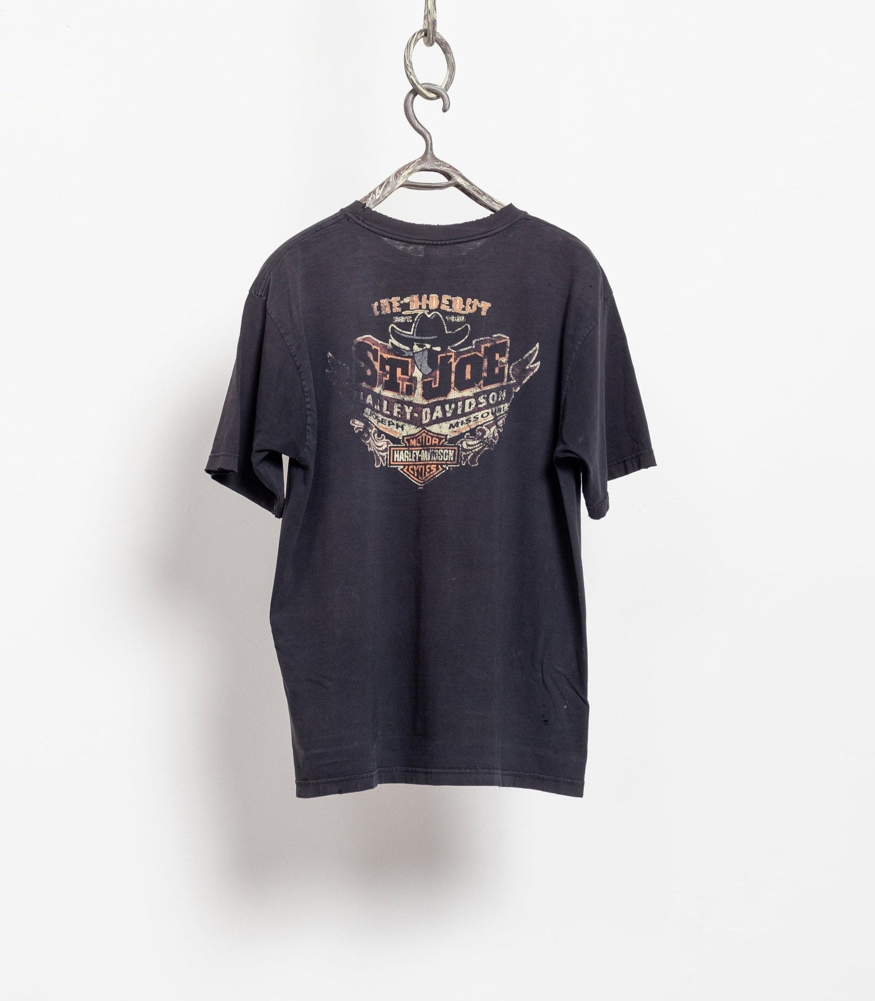 A black Harley Davidson t-shirt with a graphic on the back, hanging from a chain.